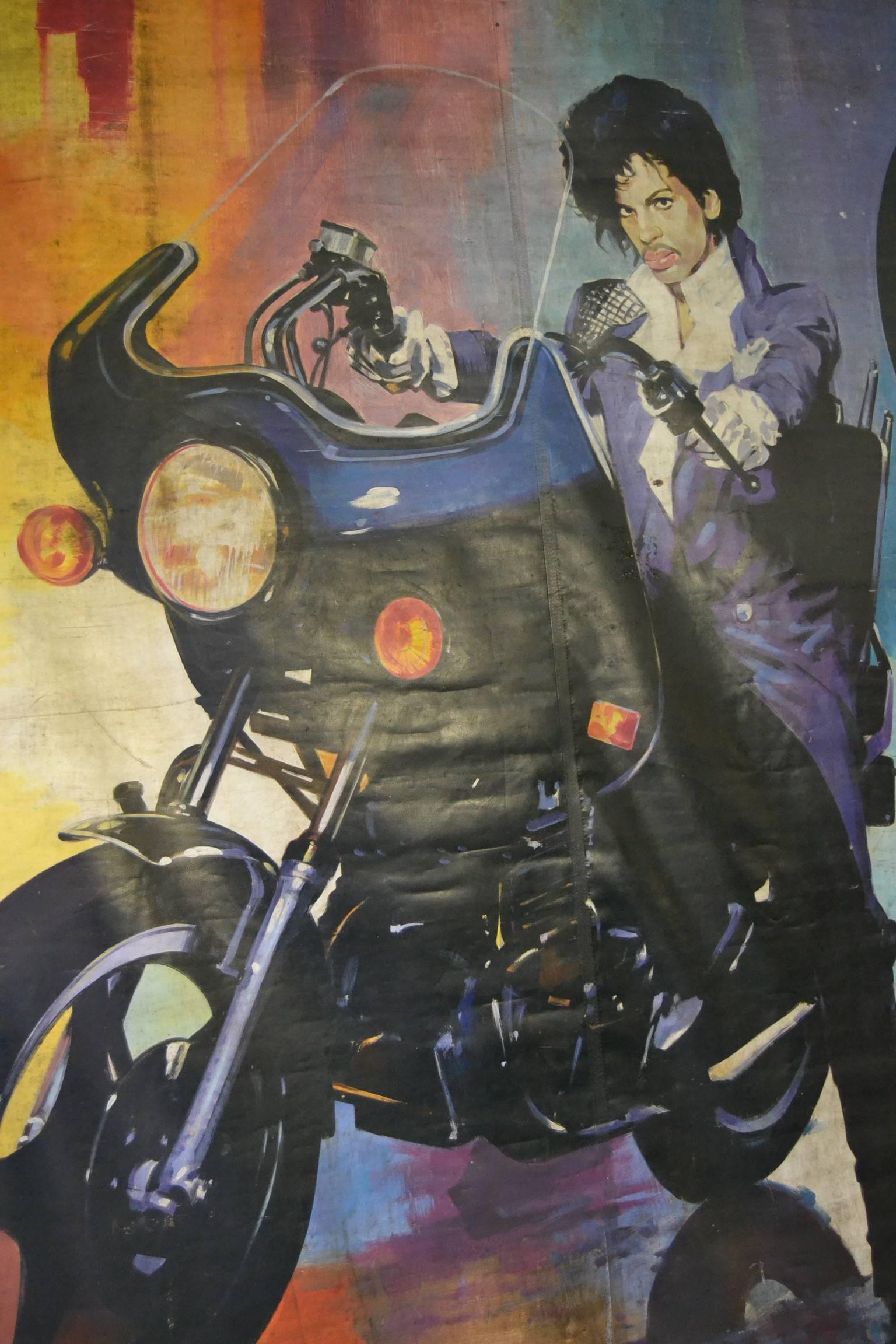 Spectacular carnivabanner with the legendary Singers Prince, Tina Turner and Fats Domino Or Percy Sledge (?)
These iconic artists - Singers are well known by every age, young and old. 
You can see Prince here at his motorbike, a typical image for