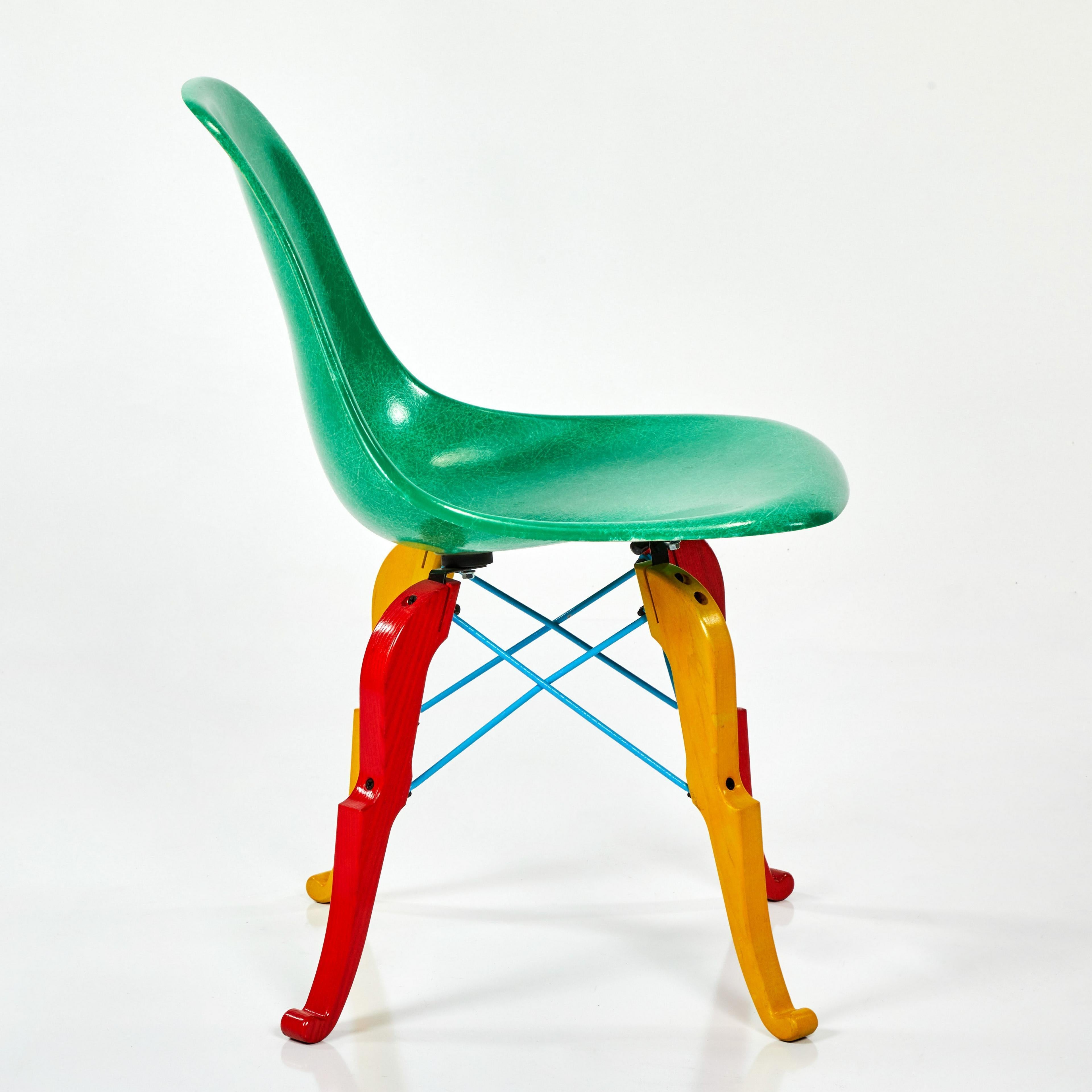 Beautiful and unique take on an Eames-style side chair produced by Modernica and designed by Peter Shire. Produced as an edition of 100 and each is hand-painted by Shire; green fiberglass seat, 'Prince Charles' base in yellow & red paint, blue