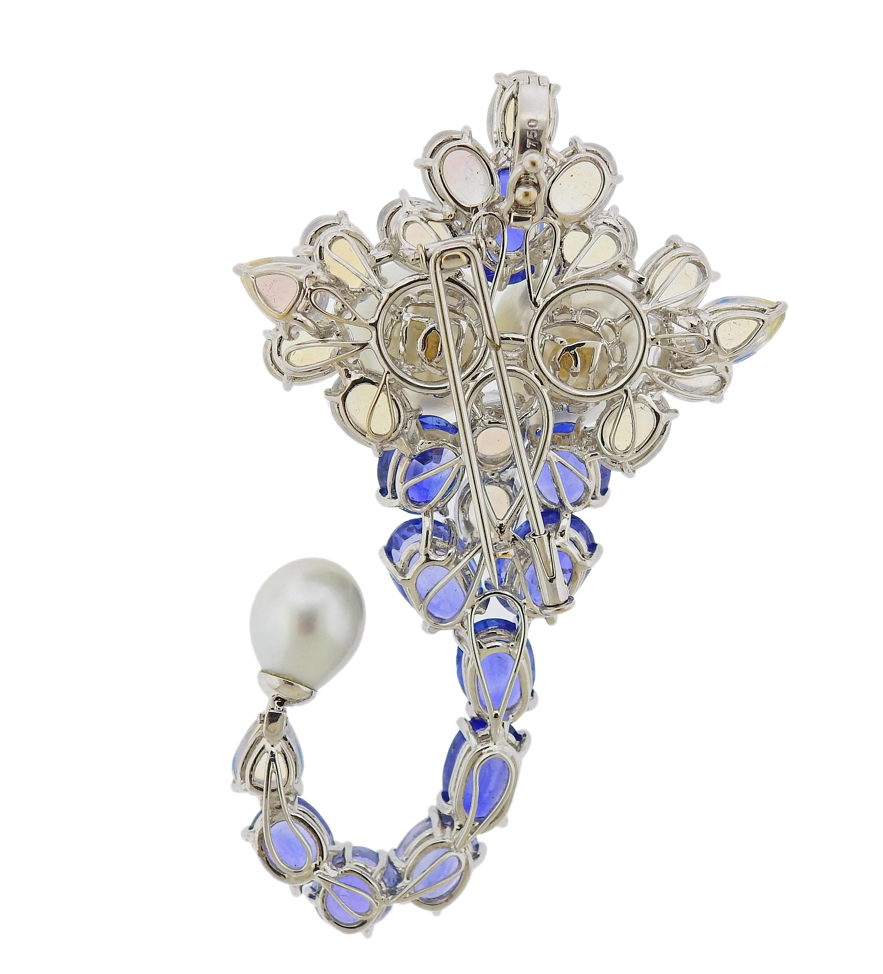 18k gold Brooch crafted by Assael for Prince Dimitri. Brooch features approximately 25.2ctw of blue sapphires, 21.10ctw in moonstone, and pearls. Retail is $27,200. Pendant/Brooch is 75mm x 47mm, Pearls are 10mm diameter; 15.1mm x 14.2mm. Total