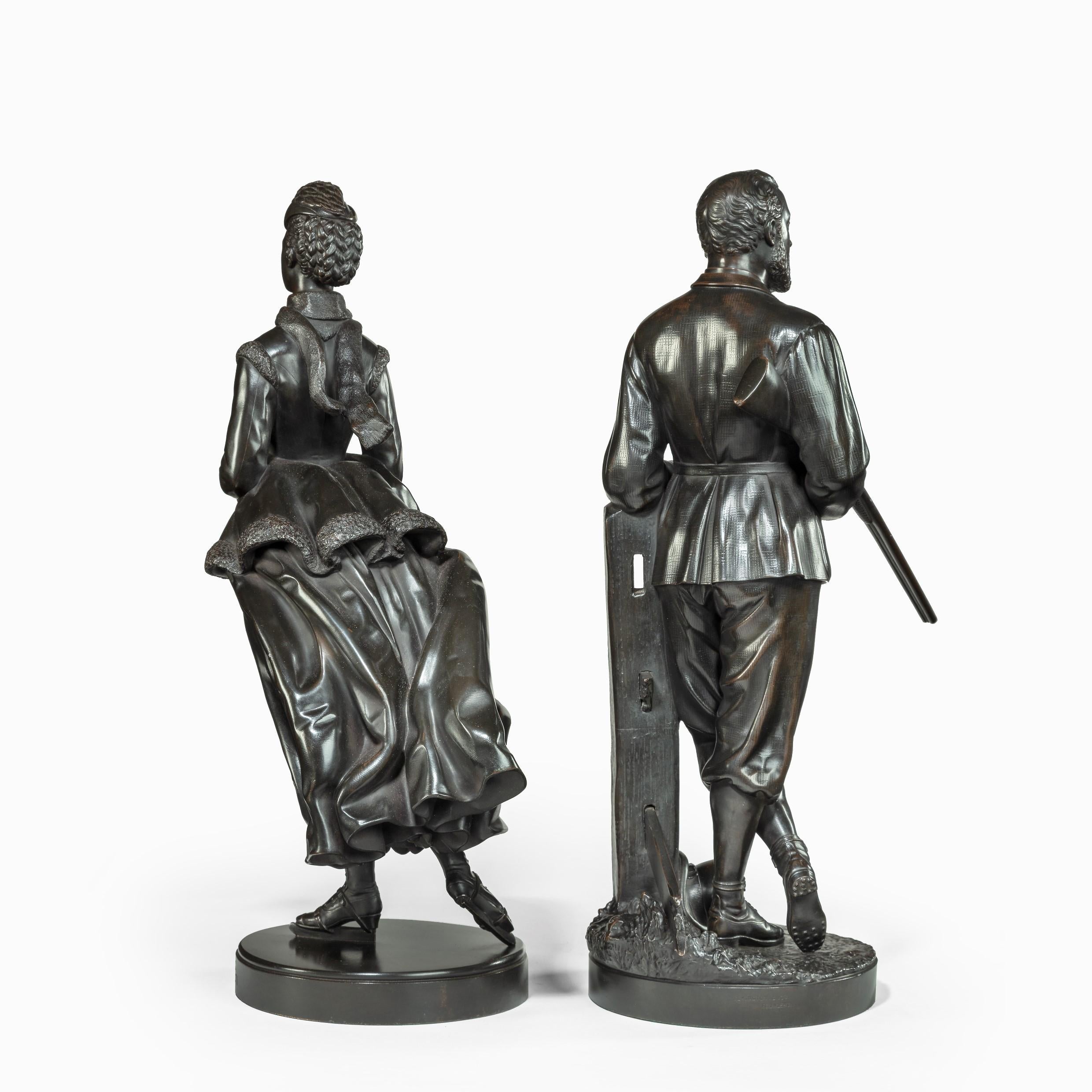 These bronze figures show Edward, Prince of Wales, standing in a nonchalant pose with one leg crossed over the other, a cigar in his left hand, his hat at his feet and a shotgun slung over his right arm. The elegant Princess of Wales is depicted