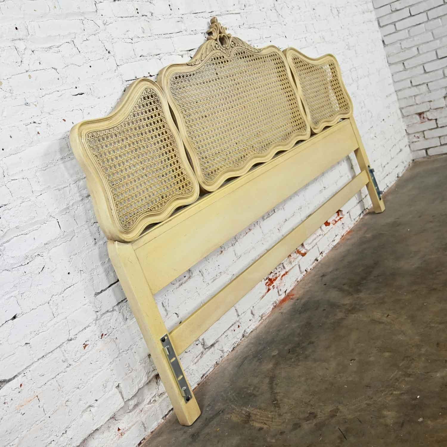 Outstanding French Provincial and Hollywood Regency style antiqued or cerused white & cane King Headboard by the Prince Howard Furniture Company. Beautiful condition, keeping in mind that this is vintage and not new so will have signs of use and