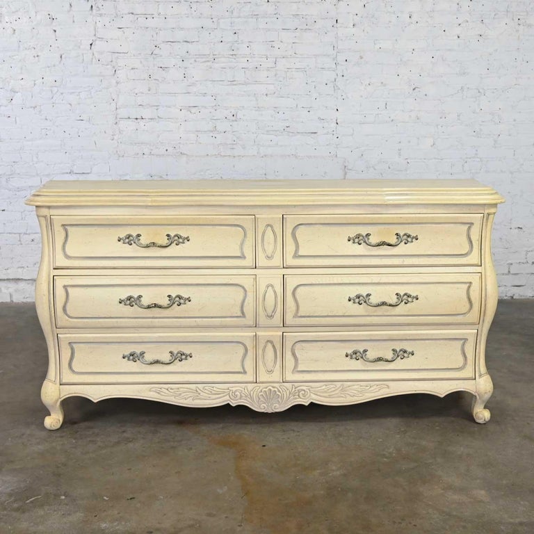 Magnificent French Provincial or Hollywood Regency style antiqued or cerused white dresser or credenza by the Prince Howard Furniture Company. Beautiful condition, keeping in mind that this is vintage and not new so will have signs of use and wear.