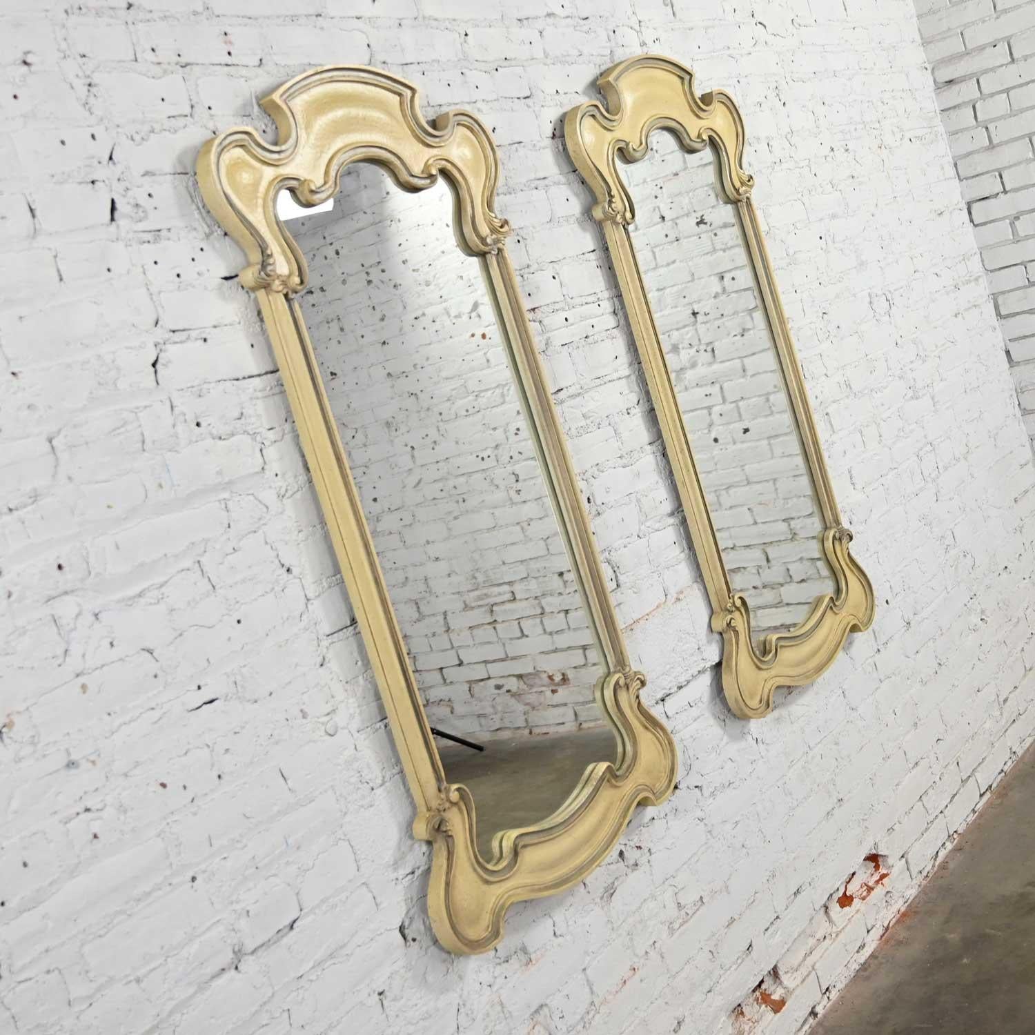 Fabulous French Provincial or Hollywood Regency style antiqued or cerused white pair of mirrors by the Prince Howard Furniture Company. Beautiful condition, keeping in mind that this is vintage and not new so will have signs of use and wear. When