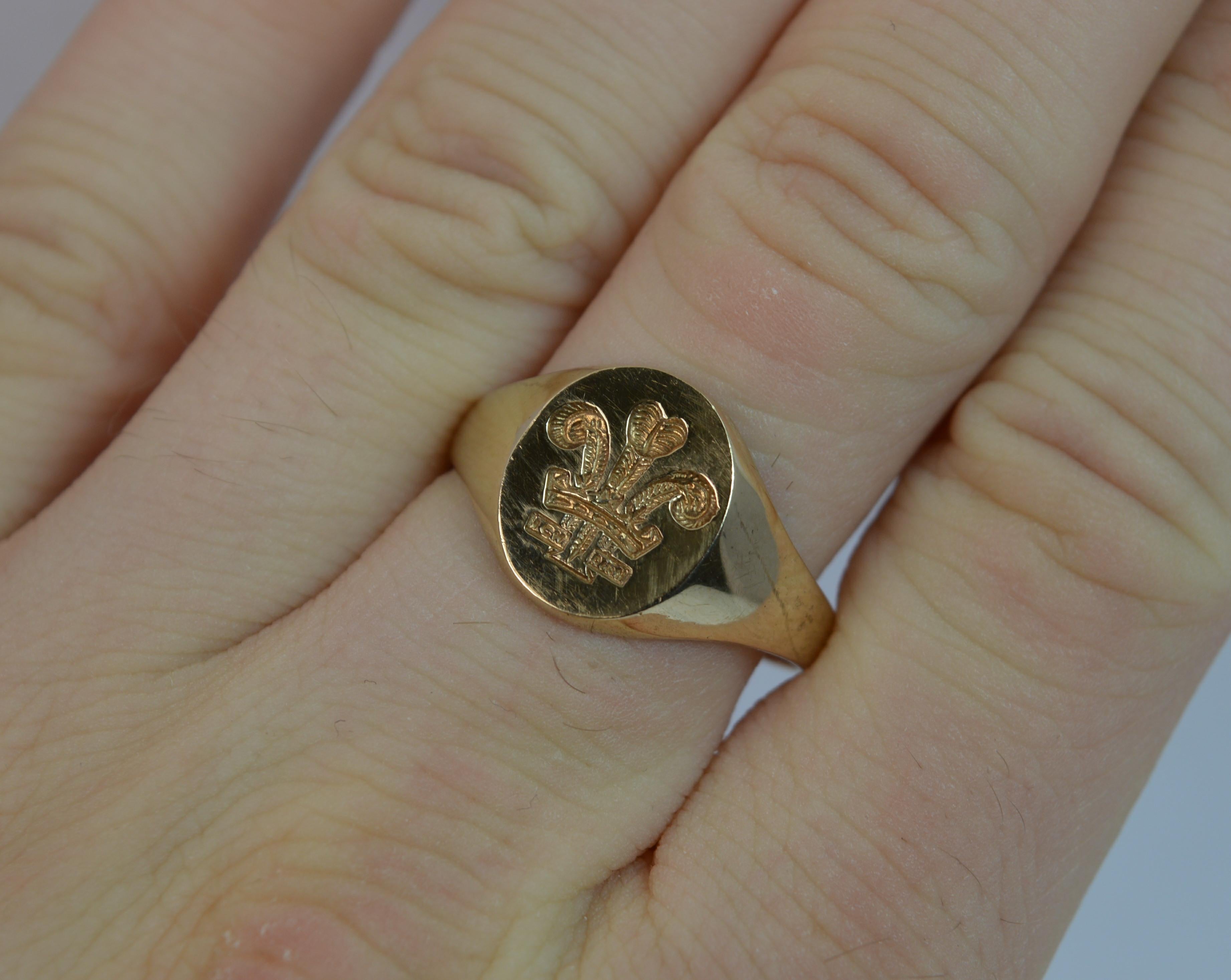 
A stylish mens or ladies signet ring.

Solid 9 carat yellow gold band.

Engraved with a Prince of Wales three feather intaglio design.

11mm x 13mm signet head.

CONDITION ; Very good. Strong, round band. Clean intaglio. Light wear. Please view