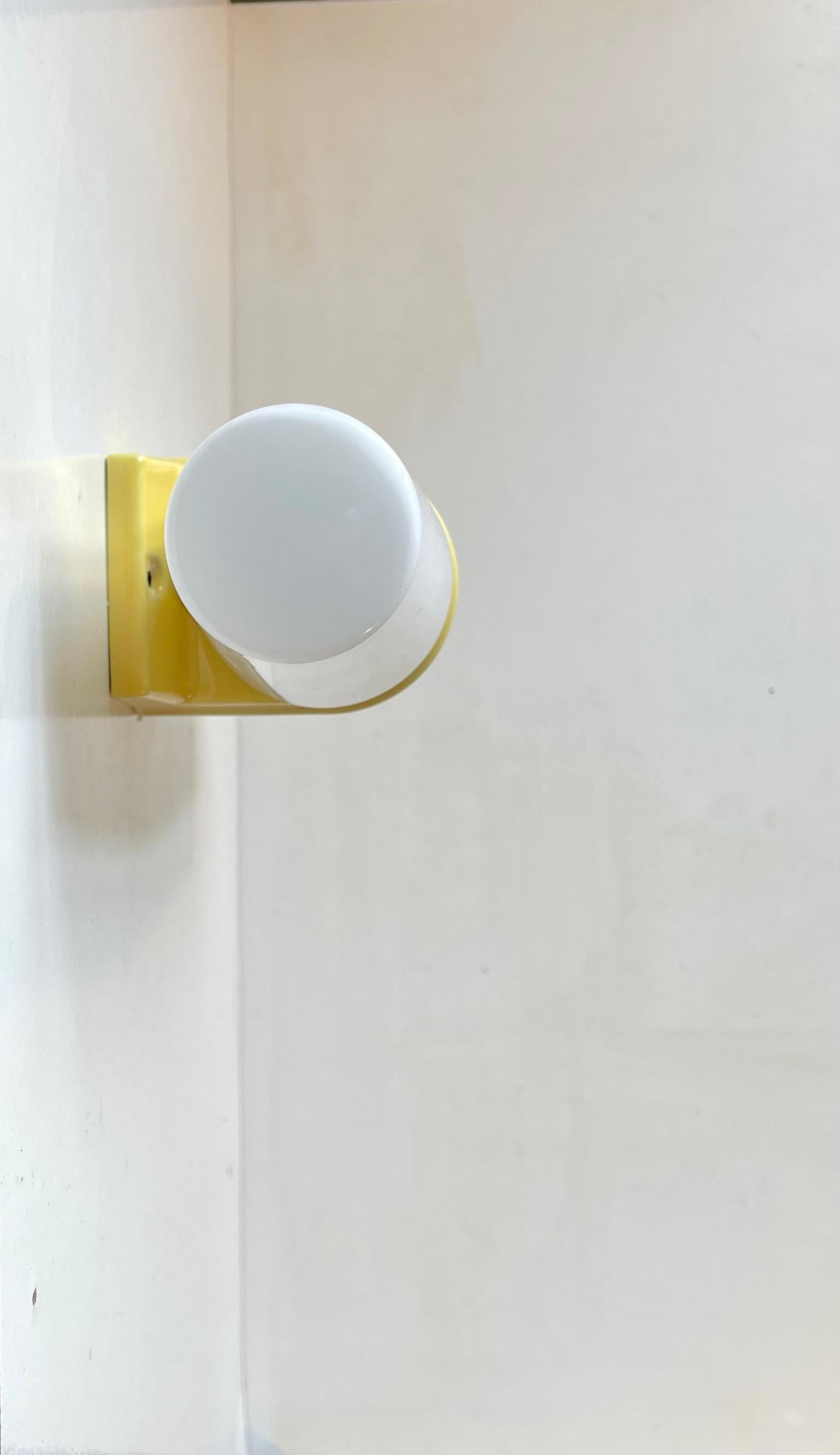 Large dual Wall sconce suitable as bathroom or outdoor lighting. Designed by Prince Sigvard Bernadotte for the swedish company Ifö during the 1960s. Yellow glazed porcelain mount with 2 white opaline glass shades. 2 way mount - vertical or
