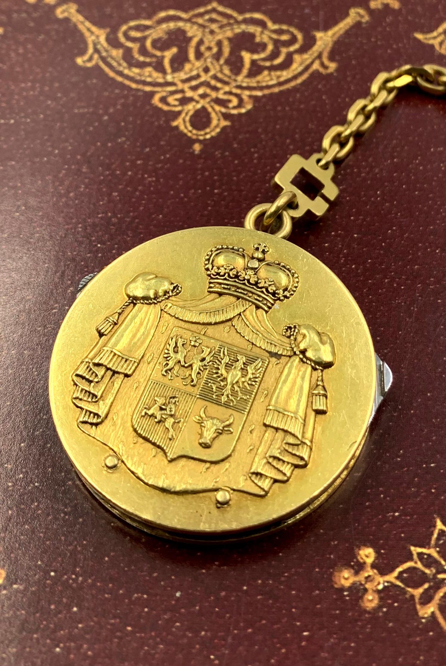 A large 18K yellow gold Prince Troubetskoy Russian Armorial cigar fob tool medallion created by Maison Arthus Bertrand with Eloi Pernet surgical steel cutting mechanism which includes cigar scissors, file and knife.
1940's
This unique 18K gold cigar
