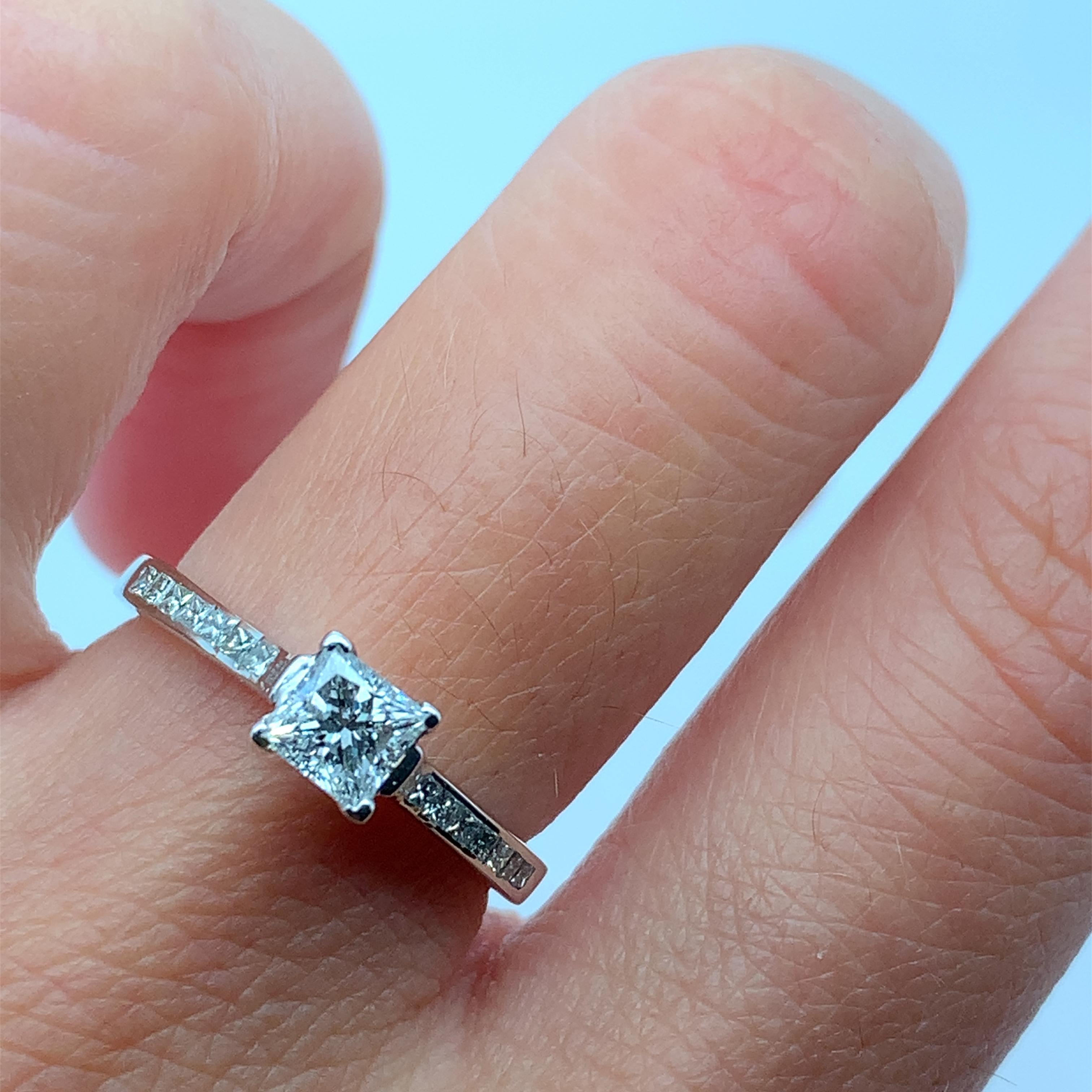 
0.65ct Princess Diamond Engagement Ring With Diamond Halo In 18k White Gold.

Classic diamond princess cut diamond engagement ring.

The ring can be resized

Hallmarked.

Center stone 0.40ct G colour VS1 clarity

0.25ct additional