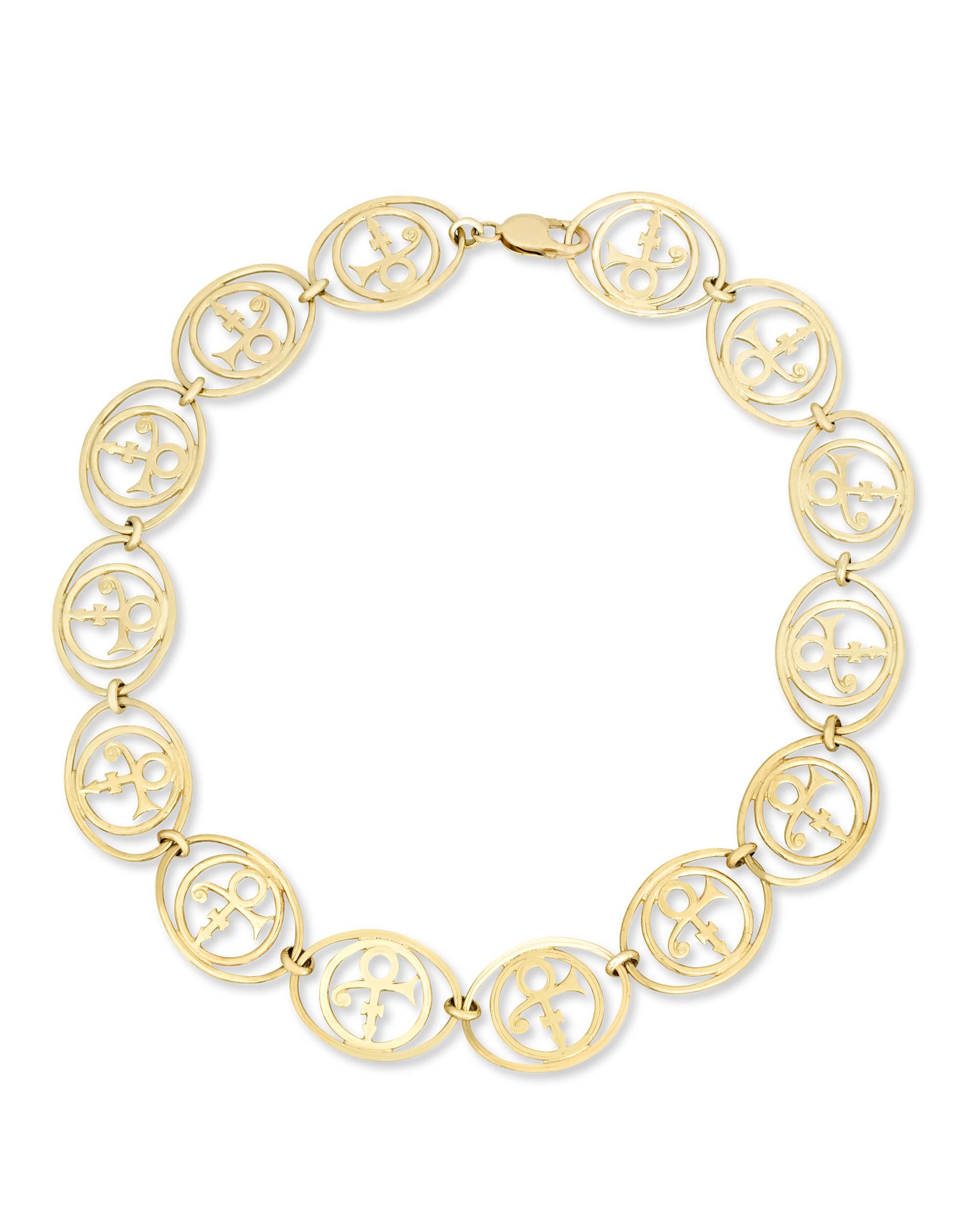 Made especially for one of the most celebrated pop icons of the modern era, this 10K yellow gold necklace was once owned by Prince. The necklace is comprised of openwork medallions that feature Prince's iconic 