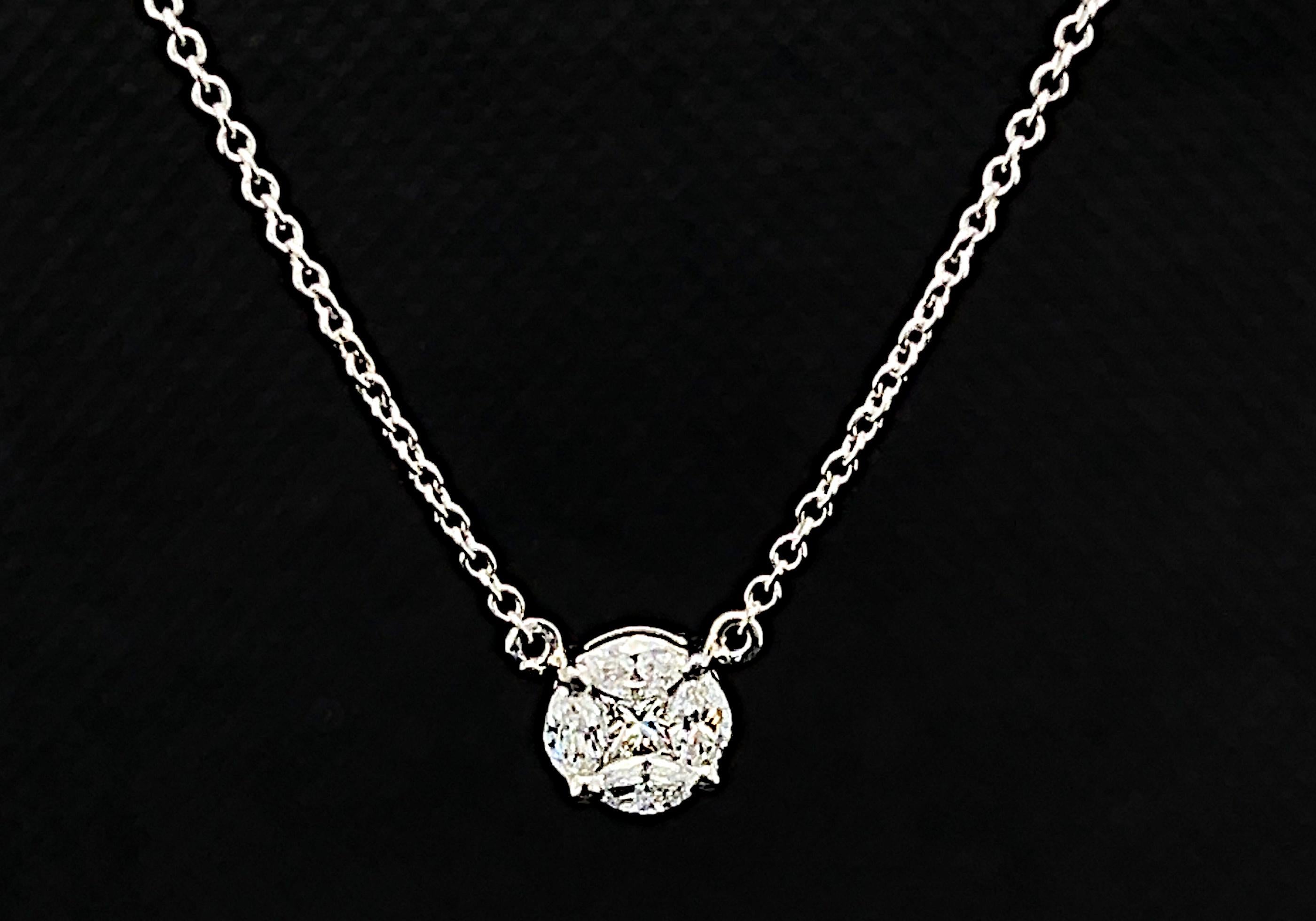 This beautiful diamond and white gold necklace features brilliant princess and marquise-cut diamonds arranged in a circle that appears to be a single, larger round diamond! Four sparkling marquise diamonds are set in 18k white gold around the