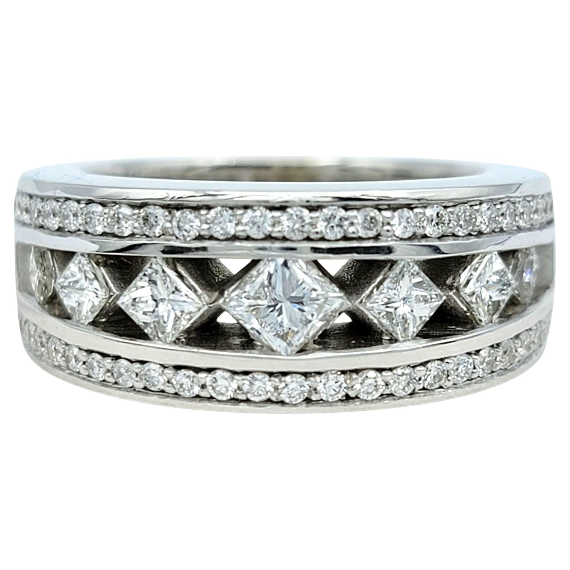 This striking diamond ring makes a bold impression with its geometric design and exceptional craftsmanship. Featuring a mix of princess and round-cut diamonds, the band offers both brilliance and structure, creating a dynamic interplay of sparkle