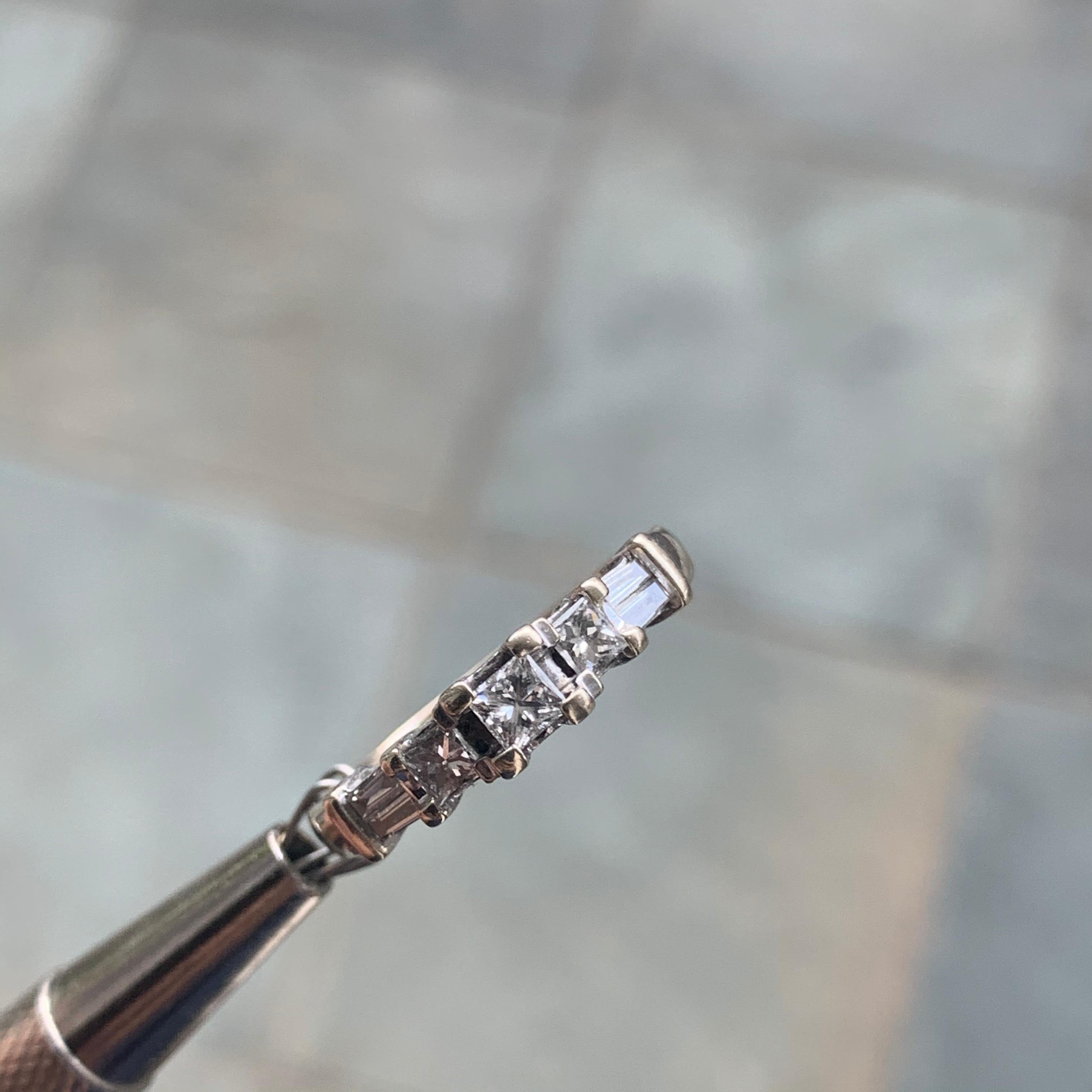 


Diamonds:

Shape: Princess and Round

1- 3mm Princess, 2 - 2.7mm Priness,  4 Tapered Baguettes

0.67 Carat TW



 