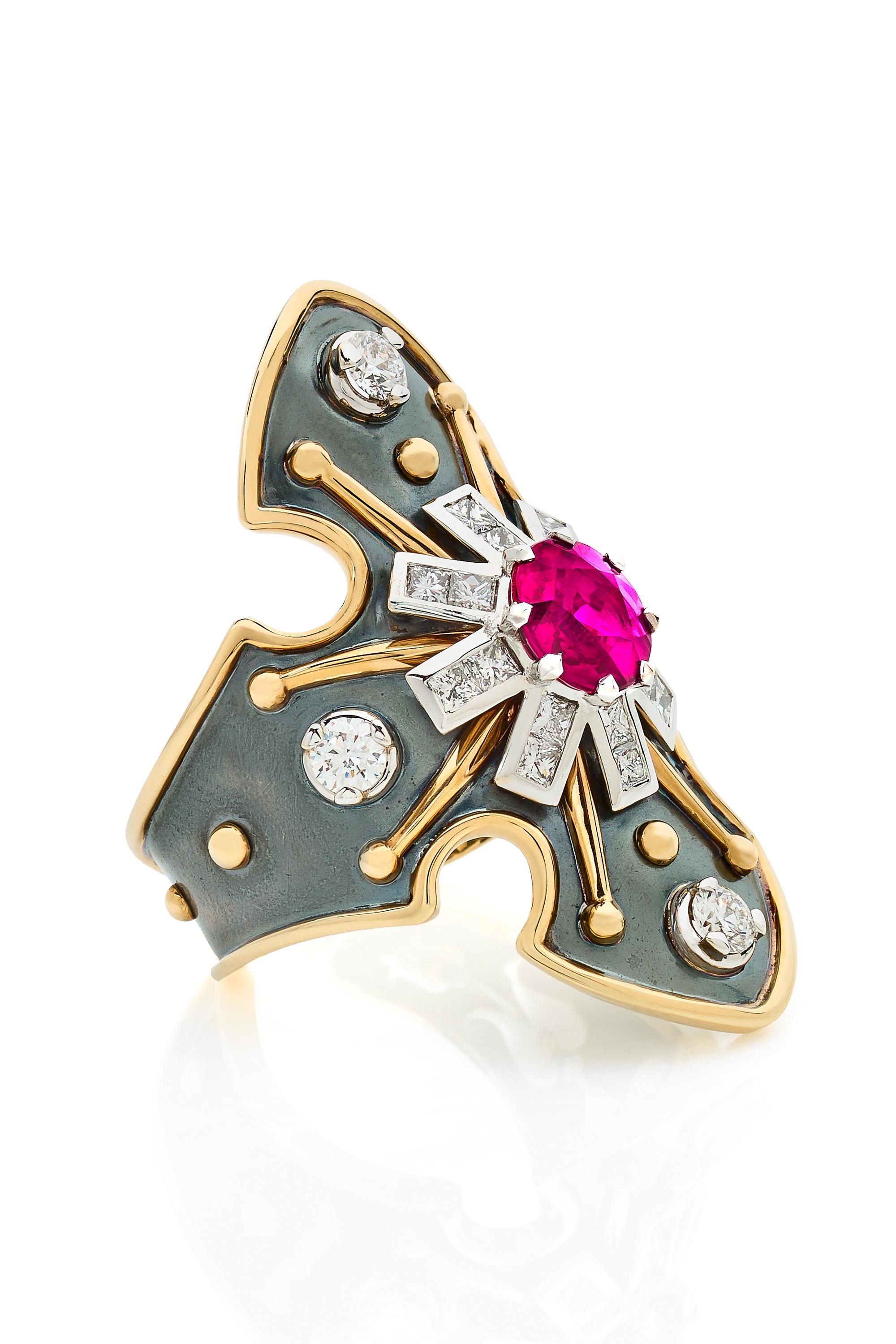 Yellow gold and distressed silver ring studded with a round burmese ruby surrounded by diamonds and set on a white gold star.

Details:
Round Burmese Ruby: 1.26 cts
Diamonds: 0.94 cts
18k Yellow Gold: 5.64 g
Distressed Silver: 5.74 g
Made in France