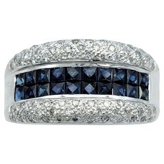 Anillo de oro blanco de 14 quilates con zafiro azul talla princesa y diamantes