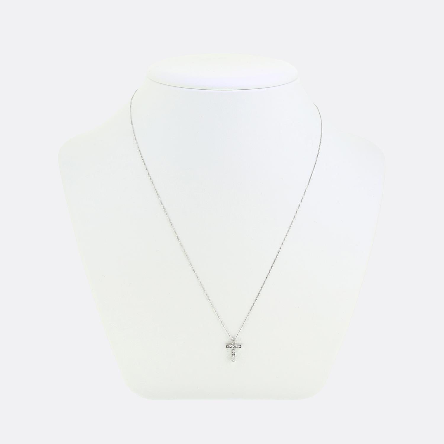 Here we have a classically styled 18ct white gold diamond cross on a 9ct white gold chain. The cross is set with a total 11 princess cut diamonds; all of which have been neatly rub-over set. 

Condition: Used (Very Good)
Weight: 1.1 grams
Necklace