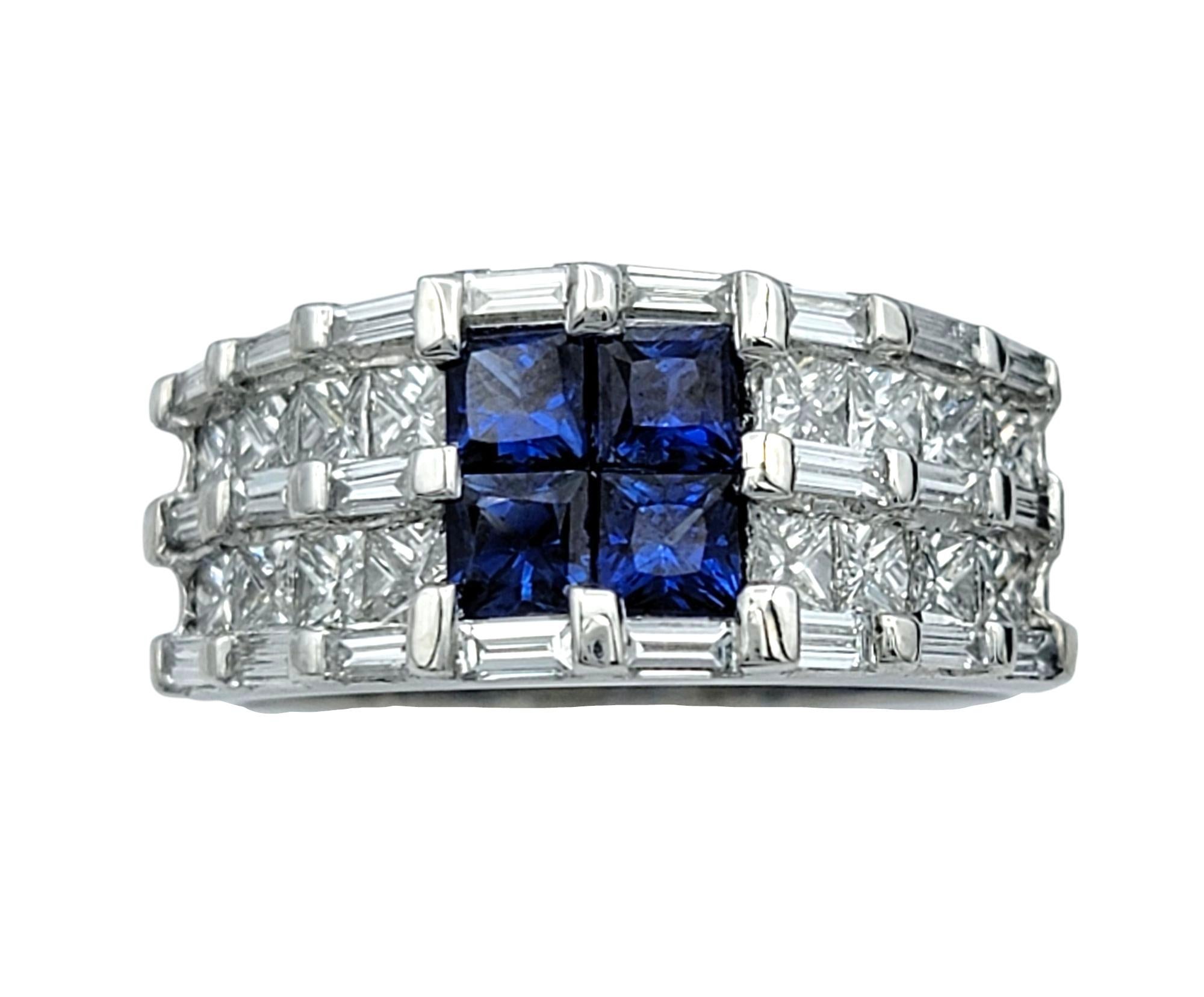 Ring Size: 6.75

This exquisite band ring showcases four mesmerizing princess-cut blue sapphires at the center, seamlessly set together to create a striking display of rich, velvety color. Framed by a brilliant array of princess and baguette-cut