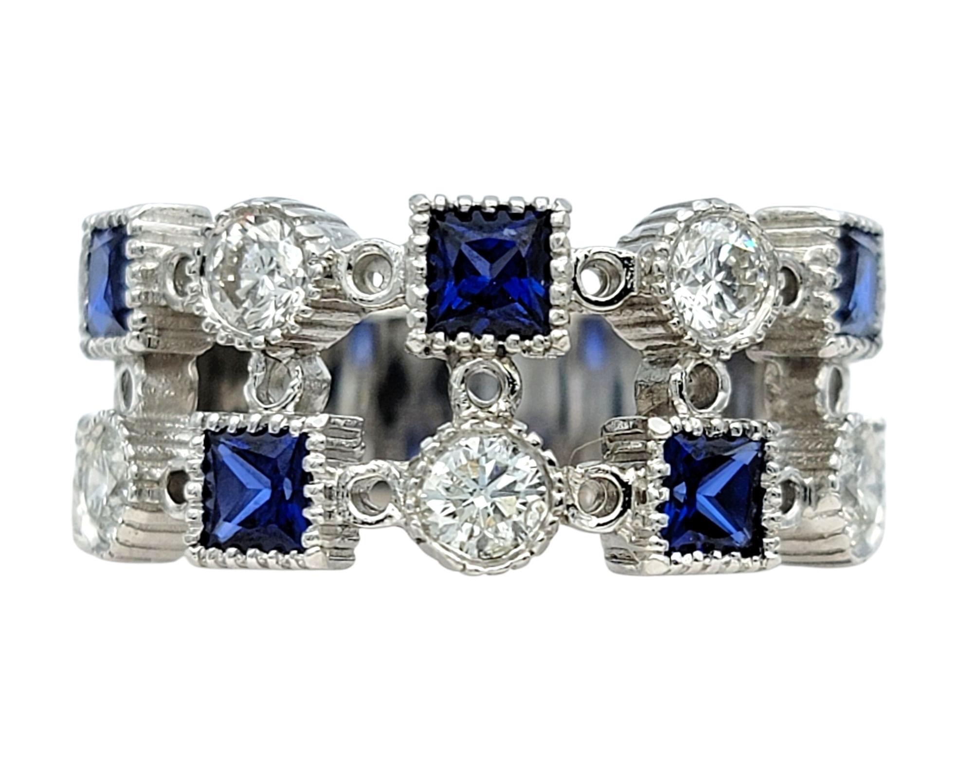Ring Size: 7.25

This bold multi-row band ring features a pattern of alternating princess-cut blue sapphires and round-cut diamonds, each set within geometric mounts that enhance their shape and brilliance. The strong contrast between the white gold