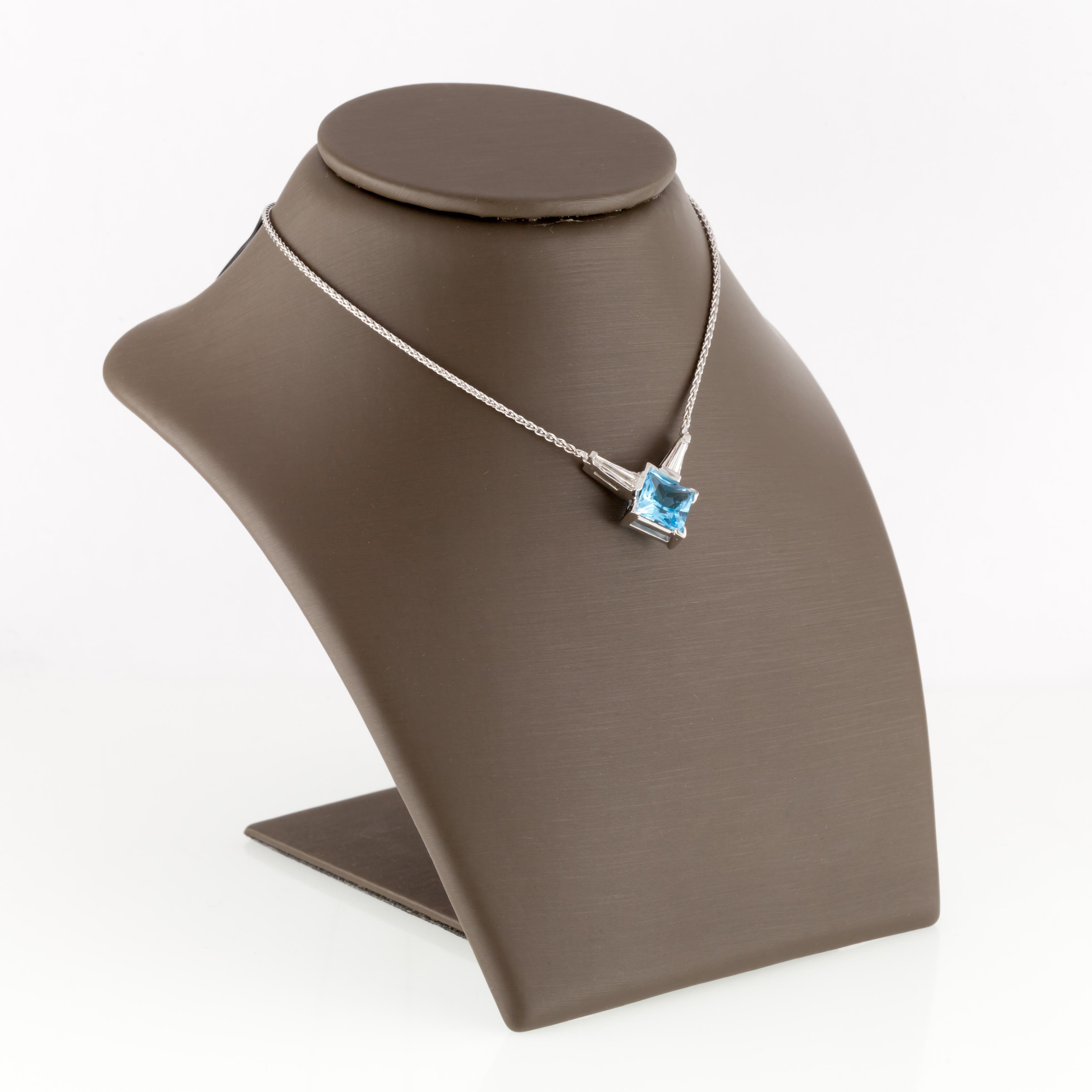Gorgeous 14k white gold pendant necklace.
Includes 14k white gold wheat chain.
Features semi-bezel set princess-cut blue topaz.
Features two tapered baguette accent diamonds.
Diamond Weight: 0.25 carats.
Length: 17 inches.
Weight: 4.8 grams.