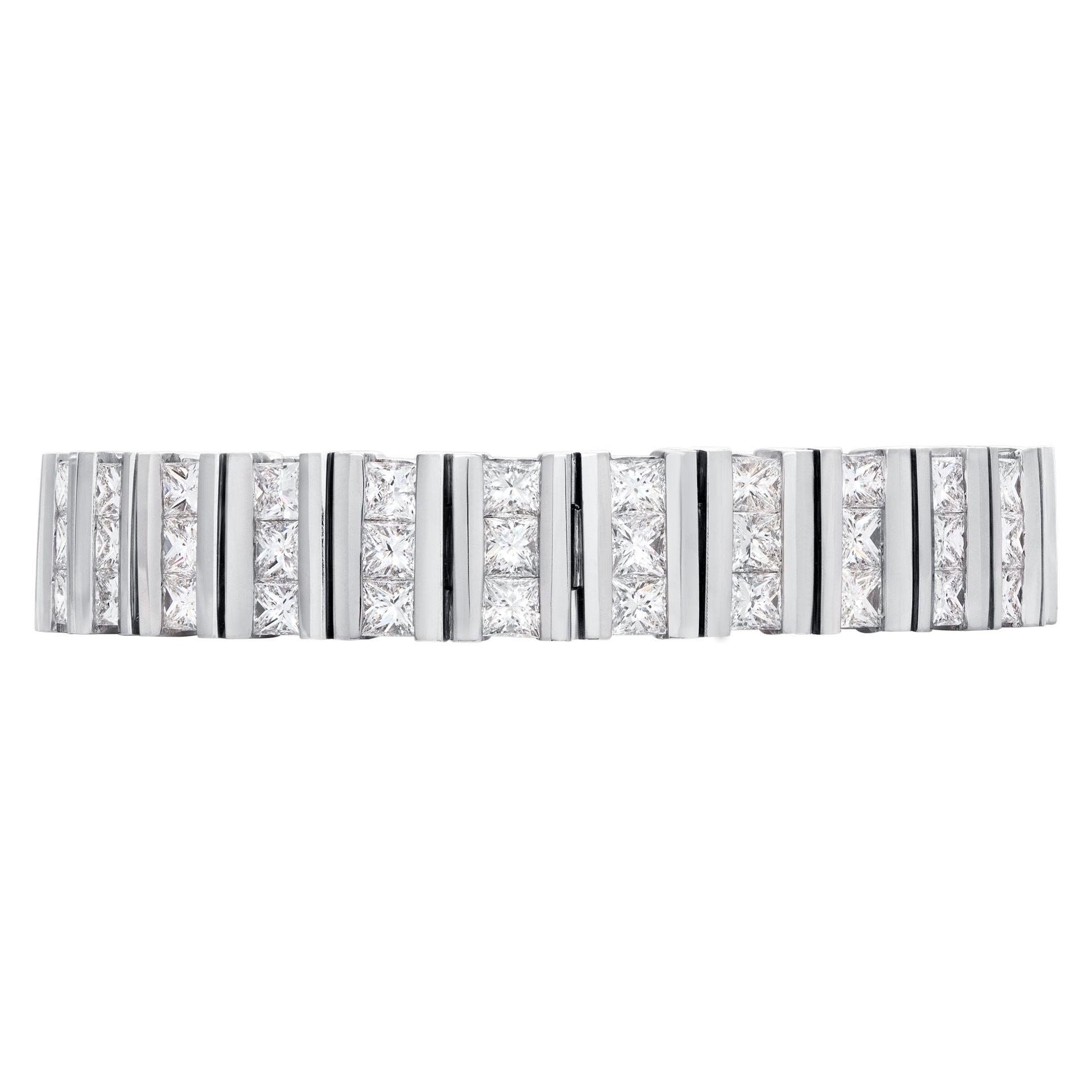 Channel set princess cut diamond bracelet in 18k white gold, over 16.20 carats in princess cut G-H color, VS-SI clarity diamonds. Width: 11.0mm. Length 7.5 inches.

