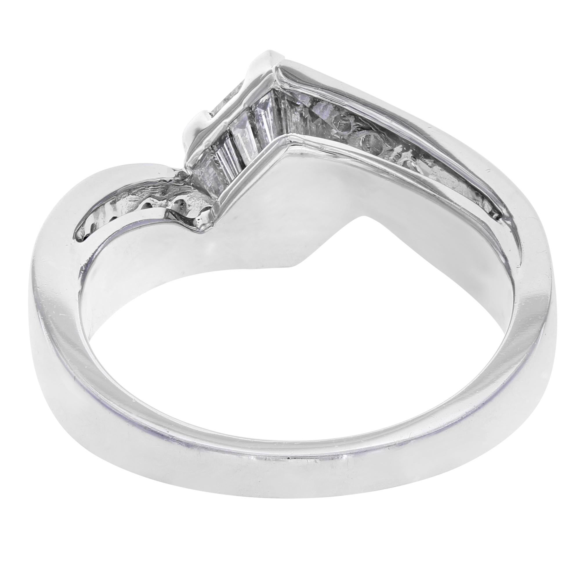 This beautiful diamond engagement ring is crafted in 14K white gold. It features a center princess cut white diamond weighing apprx. 0.62ct with 10 round brilliant cut diamond accents and 16 baguette cut white diamond stones weighing appx. 0.73ct.