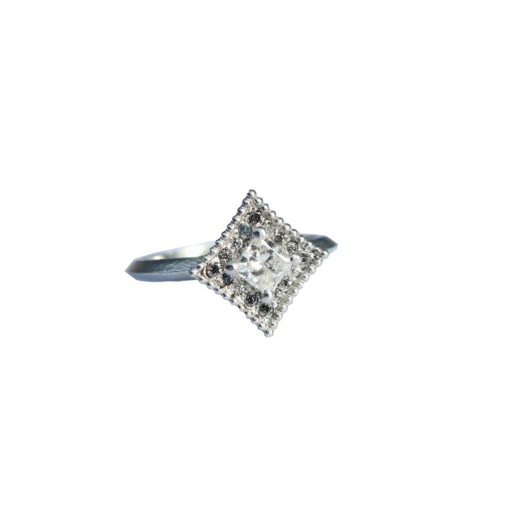 Sleek vintage inspired art deco ring featuring a princess cut .27 carat diamond surrounded by 16 bead set diamonds 1.3- 1.5mm 
Setting tapers into a knife edge band.

Center Stone .27 carat SI3- I color  3.54mm x 3.5mmx 2.67mm

Size 6

