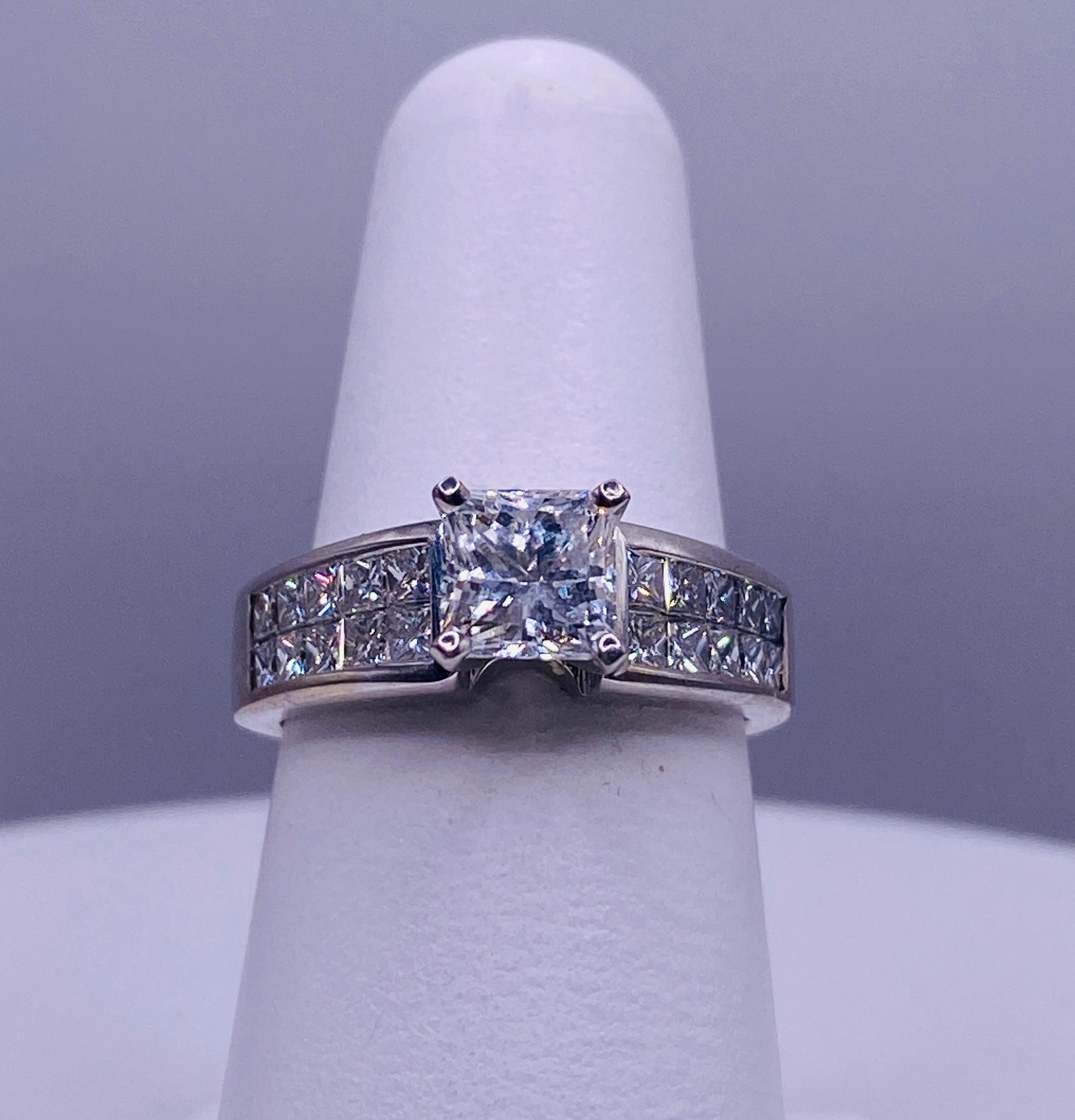 Verlobungsring aus 18 Karat Weißgold mit 1,17 Karat Diamant im Prinzessschliff G/Vs2 und 20= 1,05 Karat Gesamtgewicht unsichtbar gefassten seitlichen Diamanten. RAP $7722. Größe 6.75 US