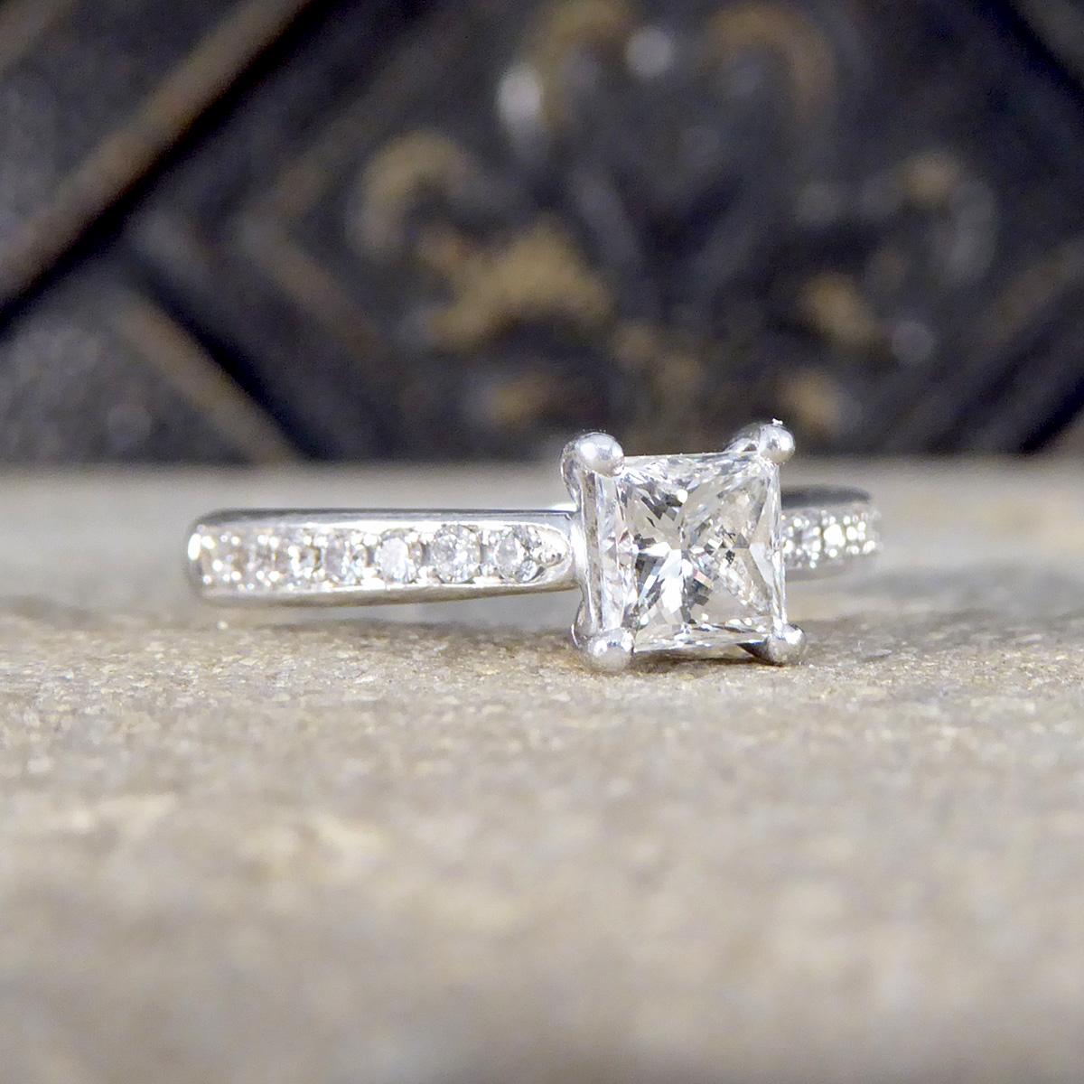 Discover the elegance of our 0.51ct Princess Cut Diamond Engagement ring, designed with Diamond set shoulders in Platinum. At its centre, a dazzling 0.51ct Princess Cut Diamond shines brilliantly, set in a refined platinum band, the Diamond has an