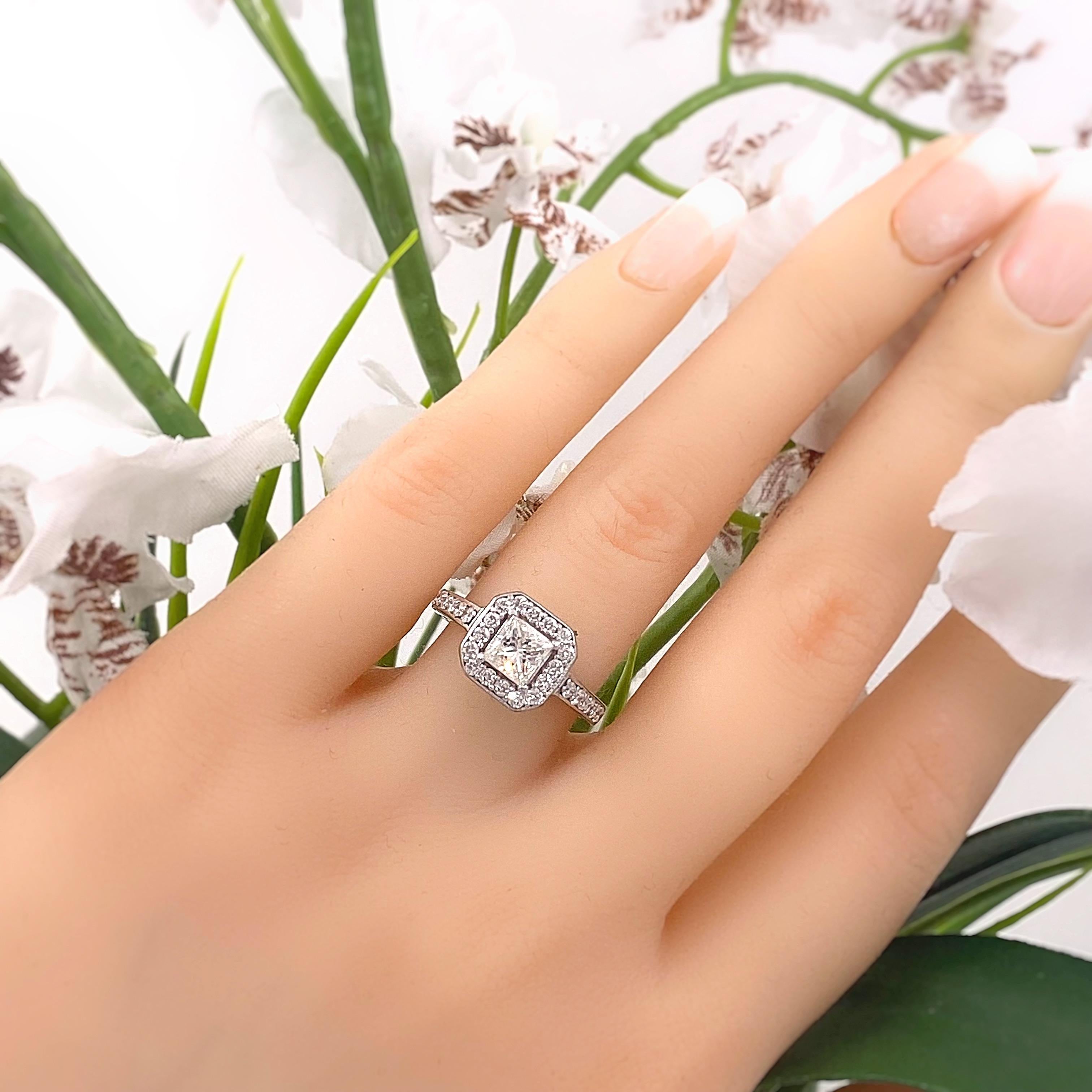 Princess Diamond Halo Engagement Ring
Style:  Halo with Diamond Band
Metal:  14kt White Gold
Size:  6 sizable
TCW:  1.45 tcw
Main Diamond:  Princess Cut Diamond 0.85 cts 
Color & Clarity:  G, I1
Accent Diamonds:   28 Round Brilliant Diamonds 0.60