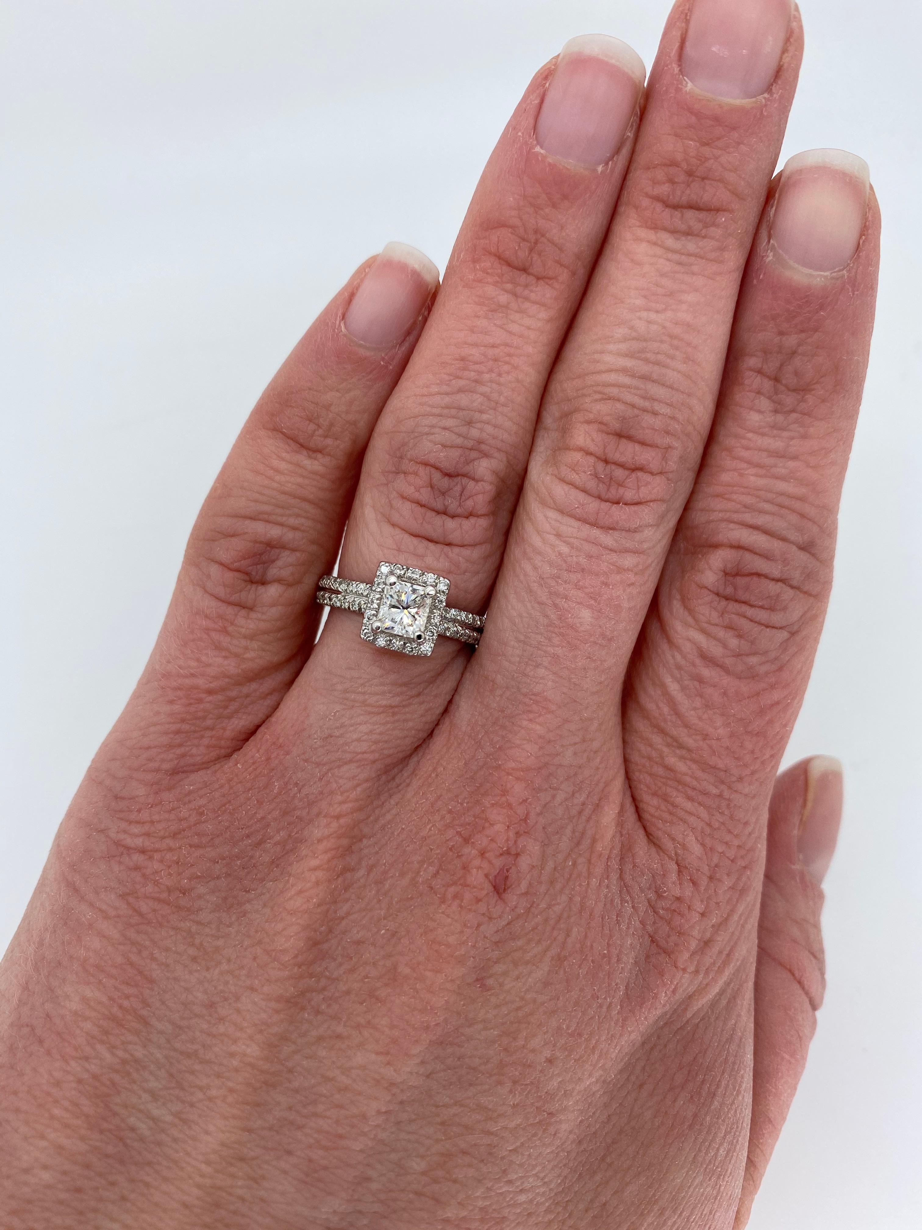 Approximately 1.15ctw halo style diamond engagement ring crafted in 18k white gold. 

Center Diamond Carat Weight: Approximately .69CT
Center Diamond Cut: Modified Rectangular Cut
Center Diamond Color: F
Center Diamond Clarity: SI1
Total Diamond