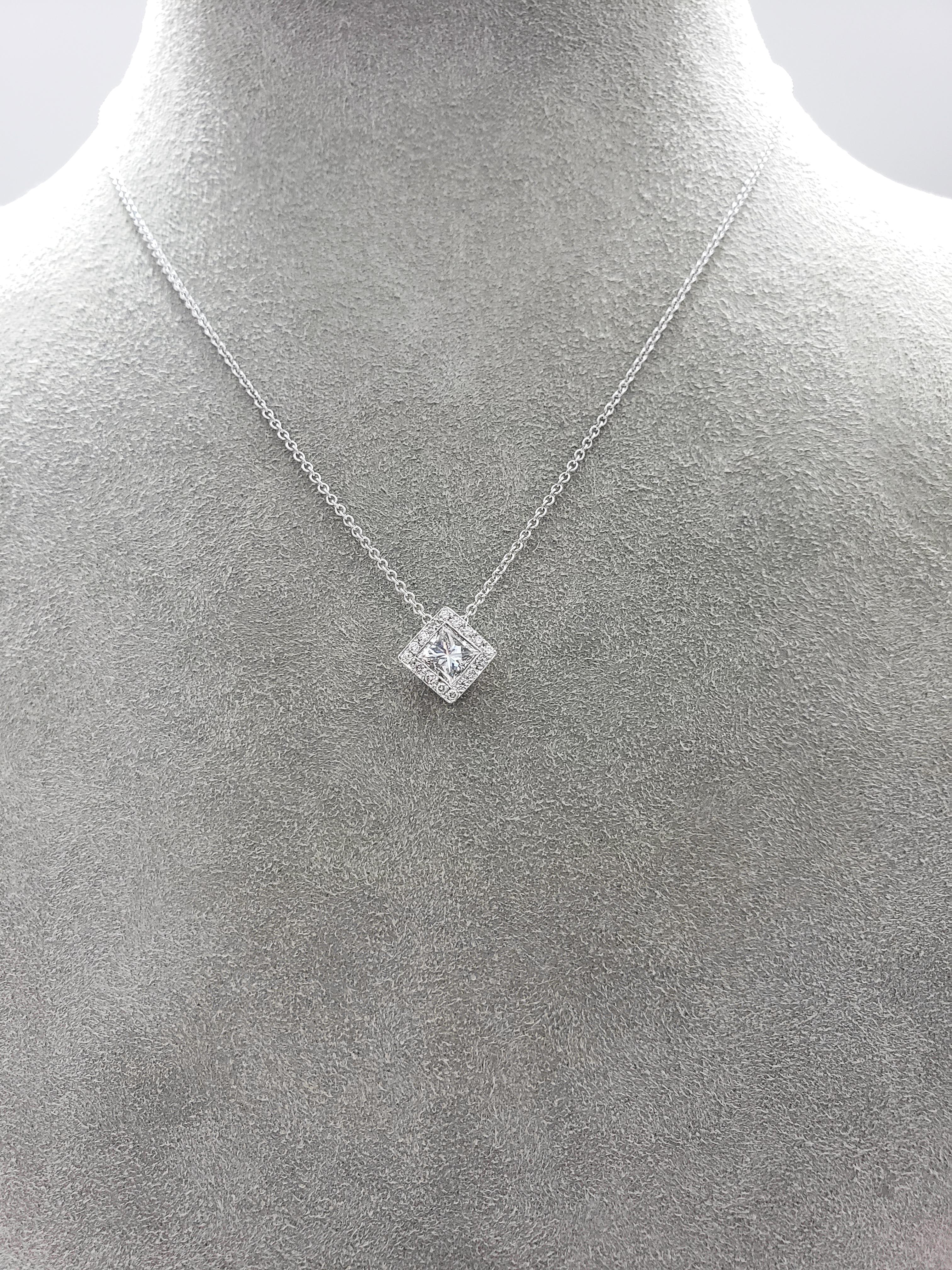 Features a 0.78 carat princess cut diamond surrounded by a row of round brilliant diamonds. Diamonds weigh 0.87 carats total. Made in 18 karat white gold. Suspended on an 18 inch white gold chain.

Style available in different price ranges. Prices