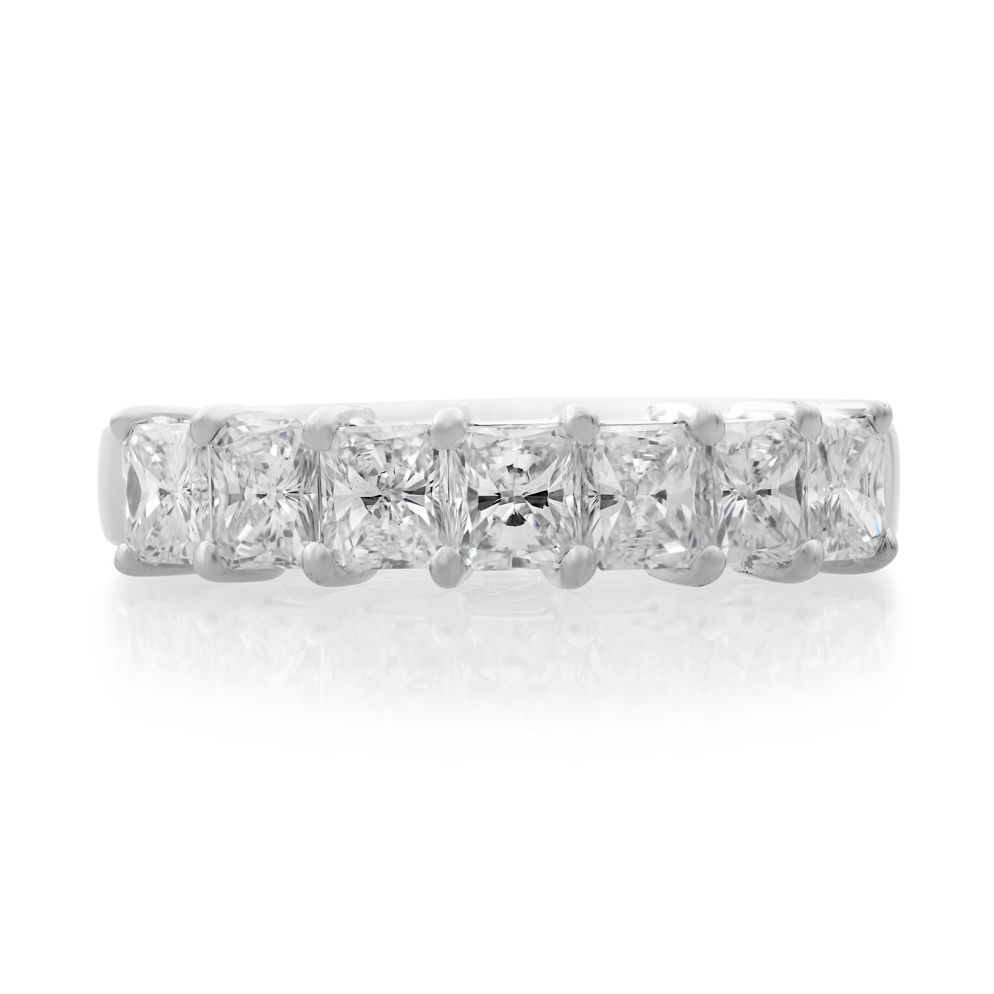 Crafted in 14k white gold, this semi eternity diamond wedding band features seven prong set princess cut diamonds across a glistening metal band. The diamonds shine brightly like stars in the night sky and are held in a prong setting for maximum