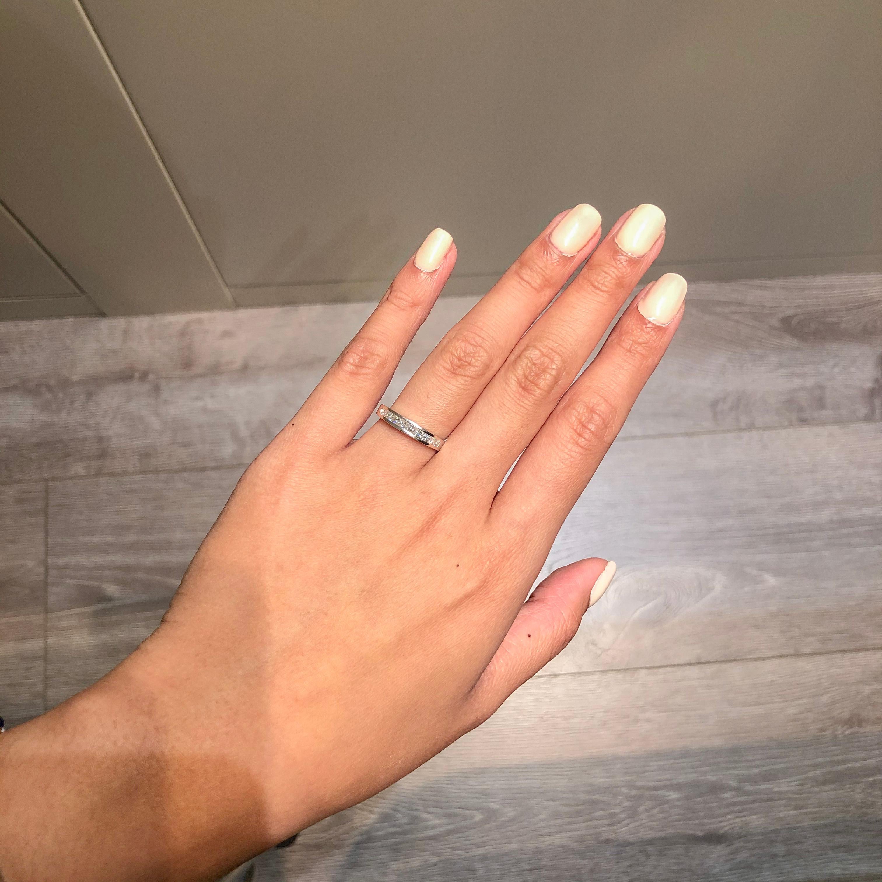 A simple wedding band featuring 10 brilliant princess cut diamonds weighing 0.56 carats total channel set in a polished platinum composition. A perfect ring for stacking or complimenting an engagement ring.

Style available in different price