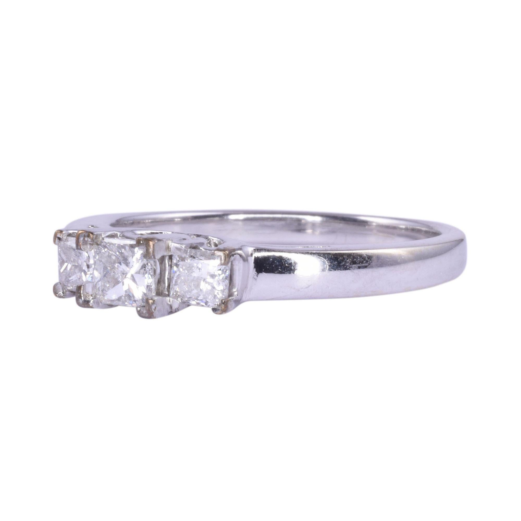 Estate princess cut diamond three stone ring. This 14 karat white gold ring features three princess cut diamonds at .50 carat total weight. The diamonds have SI2 clarity and G-H color. This three stone ring is a size 7.25. [KIMH 570]
 
*Resizing