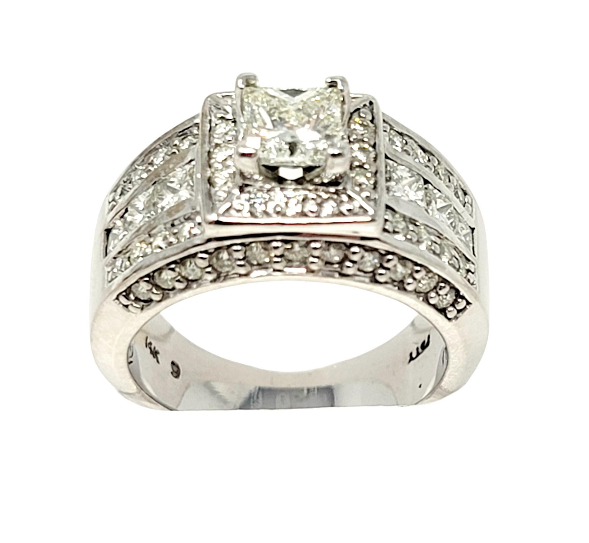 Ring size: 7.5

Beautiful princess cut diamond engagement ring with wide multi-row embellished shank. This incredibly sparkly piece is filled with diamonds from end to end. The square center stone is prong set at the center of the piece and sits