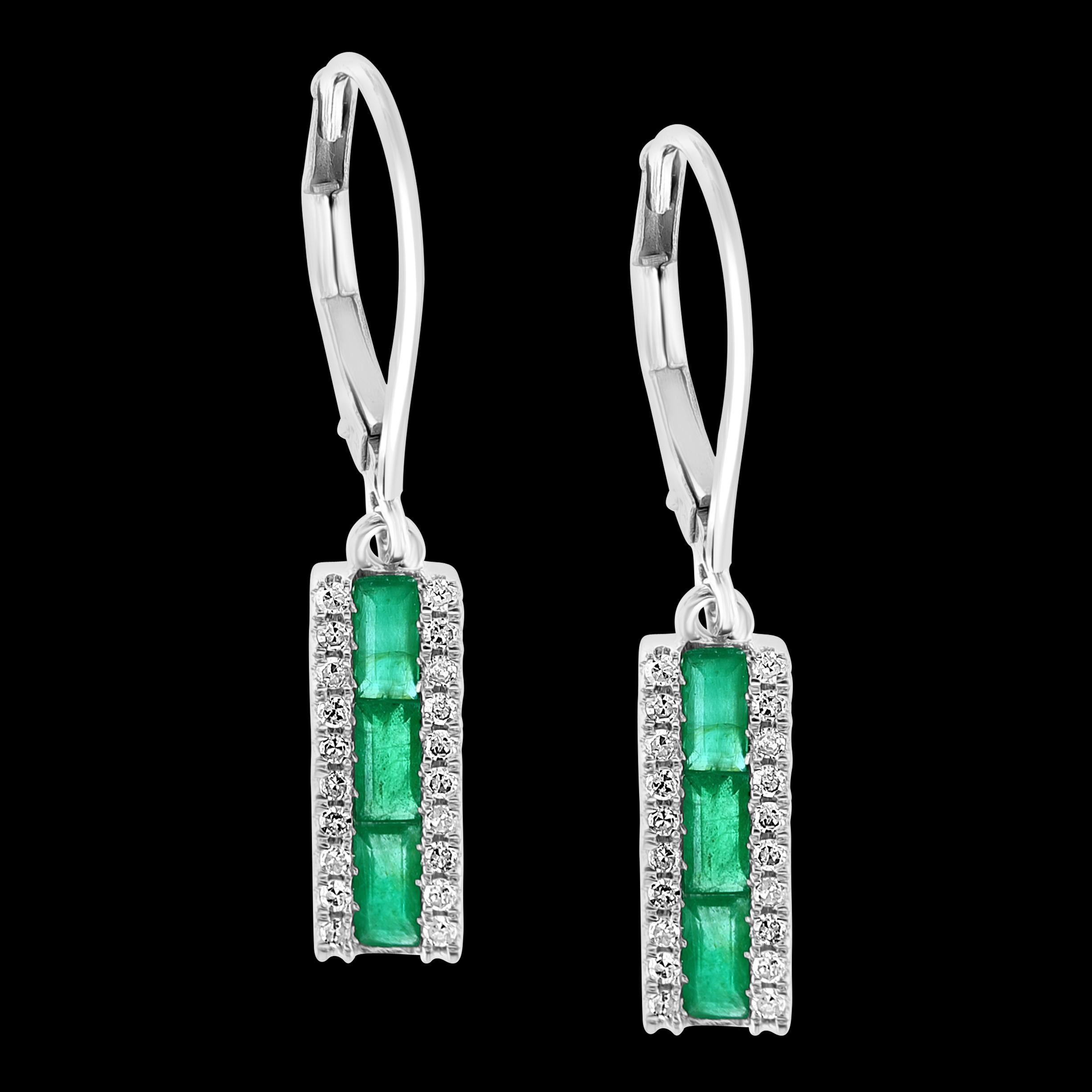 
Princess Cut  Emerald & Diamond 14 Kt White Gold Dangling Earring
Princess cut   Emerald in the Center row 
Each side of the emerald is  a diamond row 
  There are approximately 1.5 ct of emerald 
and 0.35 ct of diamonds 
14 Karat White gold 
also
