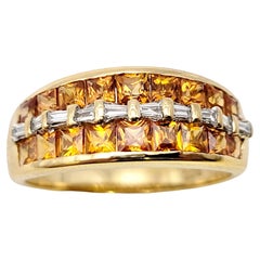 Mehrreihiger Ring aus 18 Karat Gold mit Granat im Prinzessinnenschliff und Baguette-Diamant 