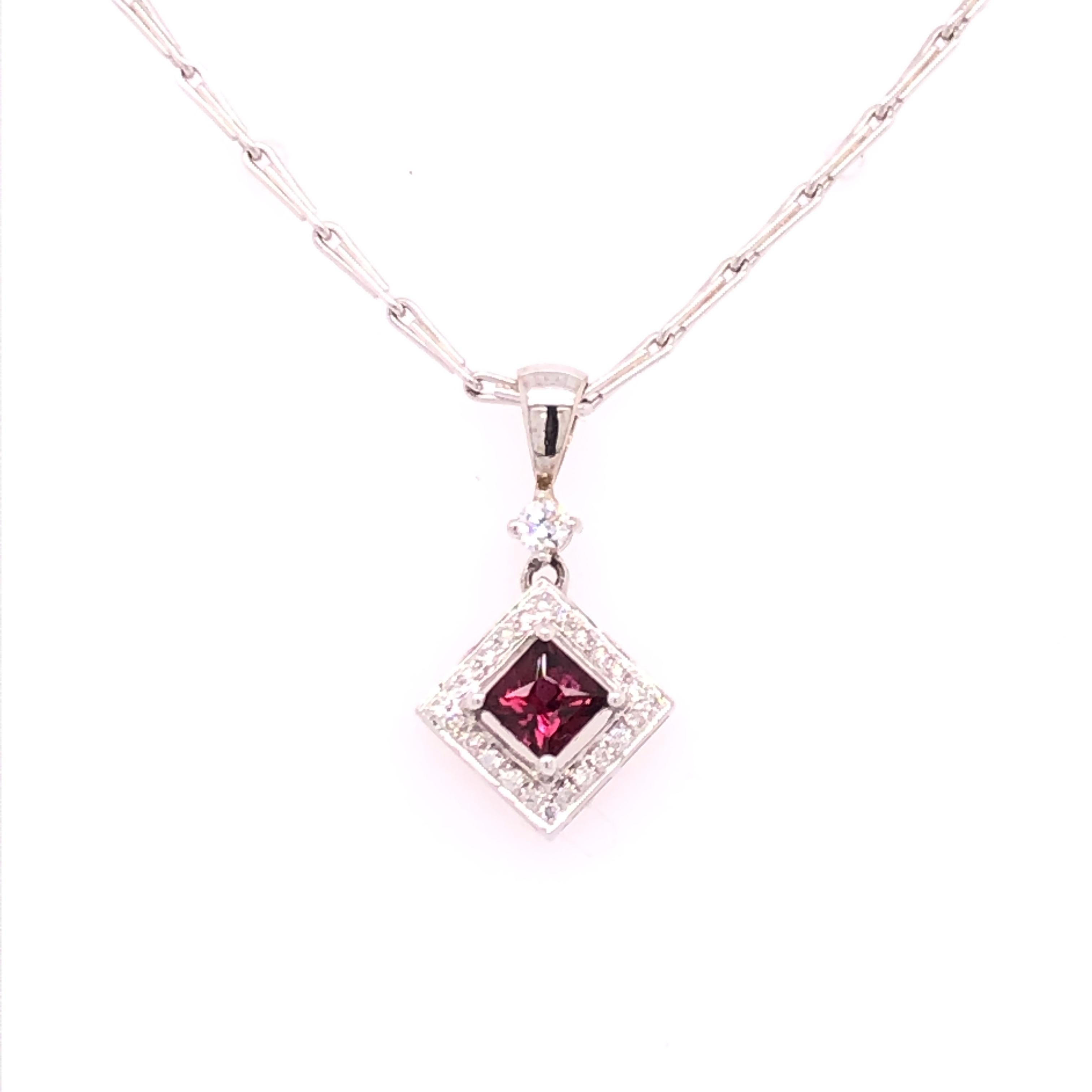 Set on its points, this princess cut pink sapphire surrounding by diamonds in a 14K white pendant drop is a beautiful example of an everyday necklace. The Sapphire is approximately 0.46 CT and the diamonds are an approximate total weight of 0.15 CT.
