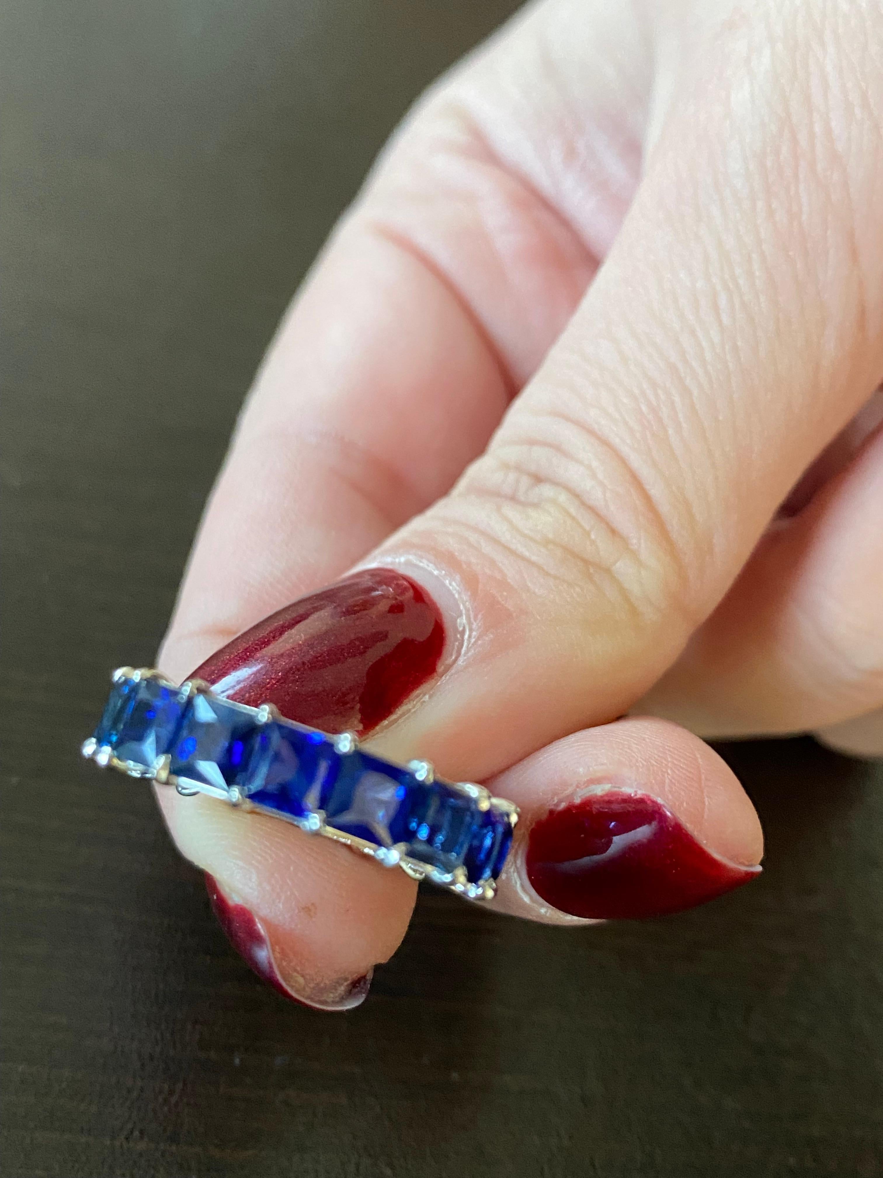 Princess cut sapphires set in 14K white gold. Each stone weighs approximately 0.40 carats, total weight is 6.77 carats. The band is set with 17 stones. The sapphires are Ceylon. The ring is a size 6 and can be sized.