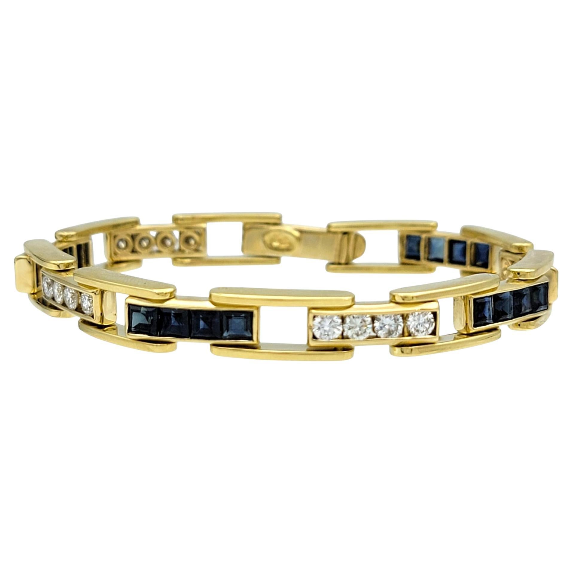 This elegant bracelet features a seamless blend of channel-set princess-cut blue sapphires alternating with round-cut diamonds along its length. The geometric precision of the sapphires is contrasted beautifully by the soft brilliance of the