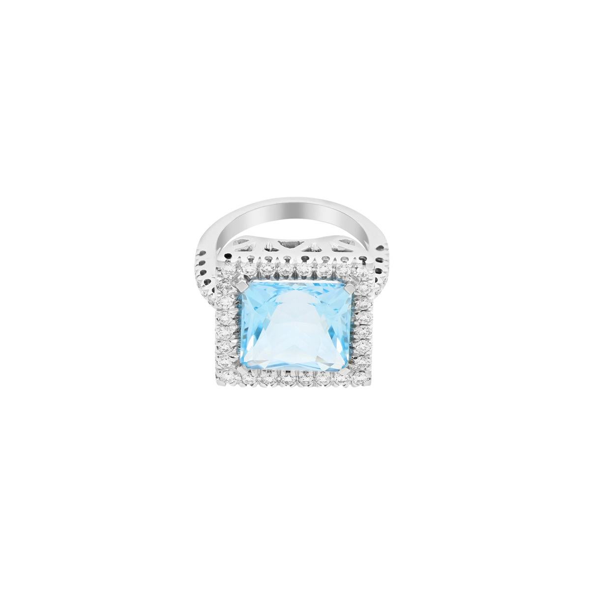 This fairy-tale-inspired ring features a princess-cut topaz with a diamond halo. It is centered on an 18 Kt white gold, diamond-pavé shank. Topaz is the birthstone of December and the stone is usually the go-to gift for the 4th and 19th