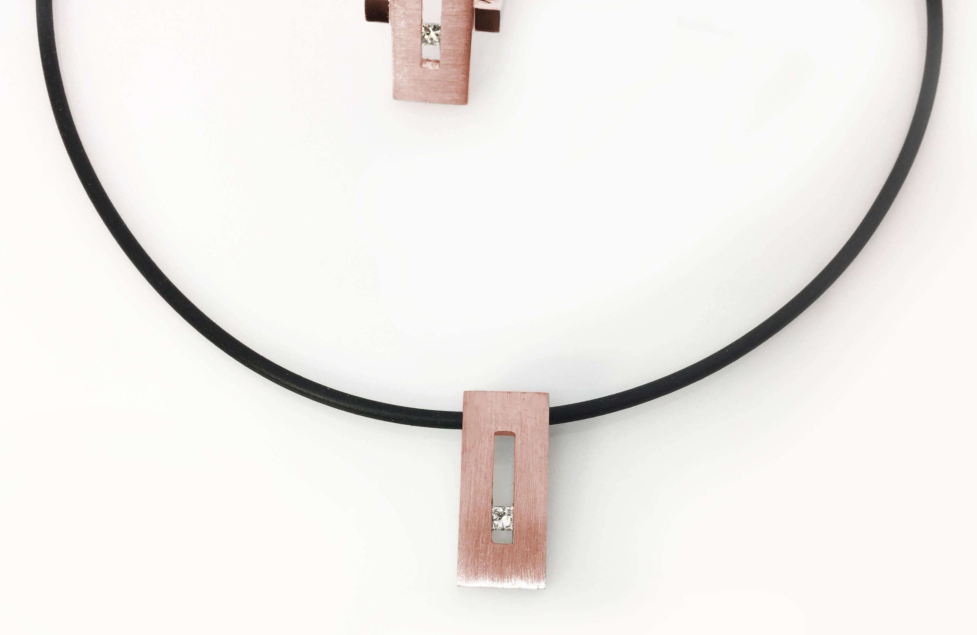 This Princess Diamond in Rose Gold Rectangle Pendant on Rubber Cord is part of our Suspension Collection. Modern and architecturally inspired, this rectangle pendant is shown in rose gold with a brushed finish and set off center with an
