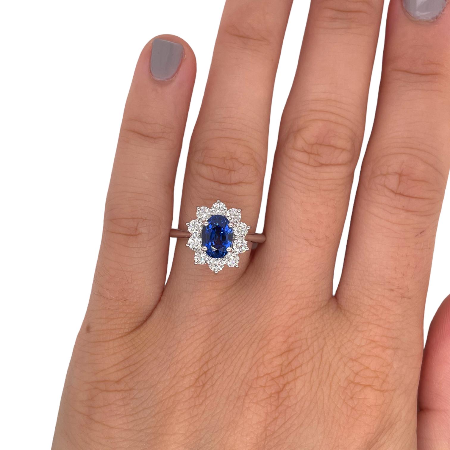 Ring contains one center certified oval shape sapphire weighing 1.94ct. Center stone is surrounded by 10 round brilliant diamonds, 1.00tcw. Sapphire and diamonds are mounted in handmade prong settings. Diamonds are F in color and VS2 in clarity.