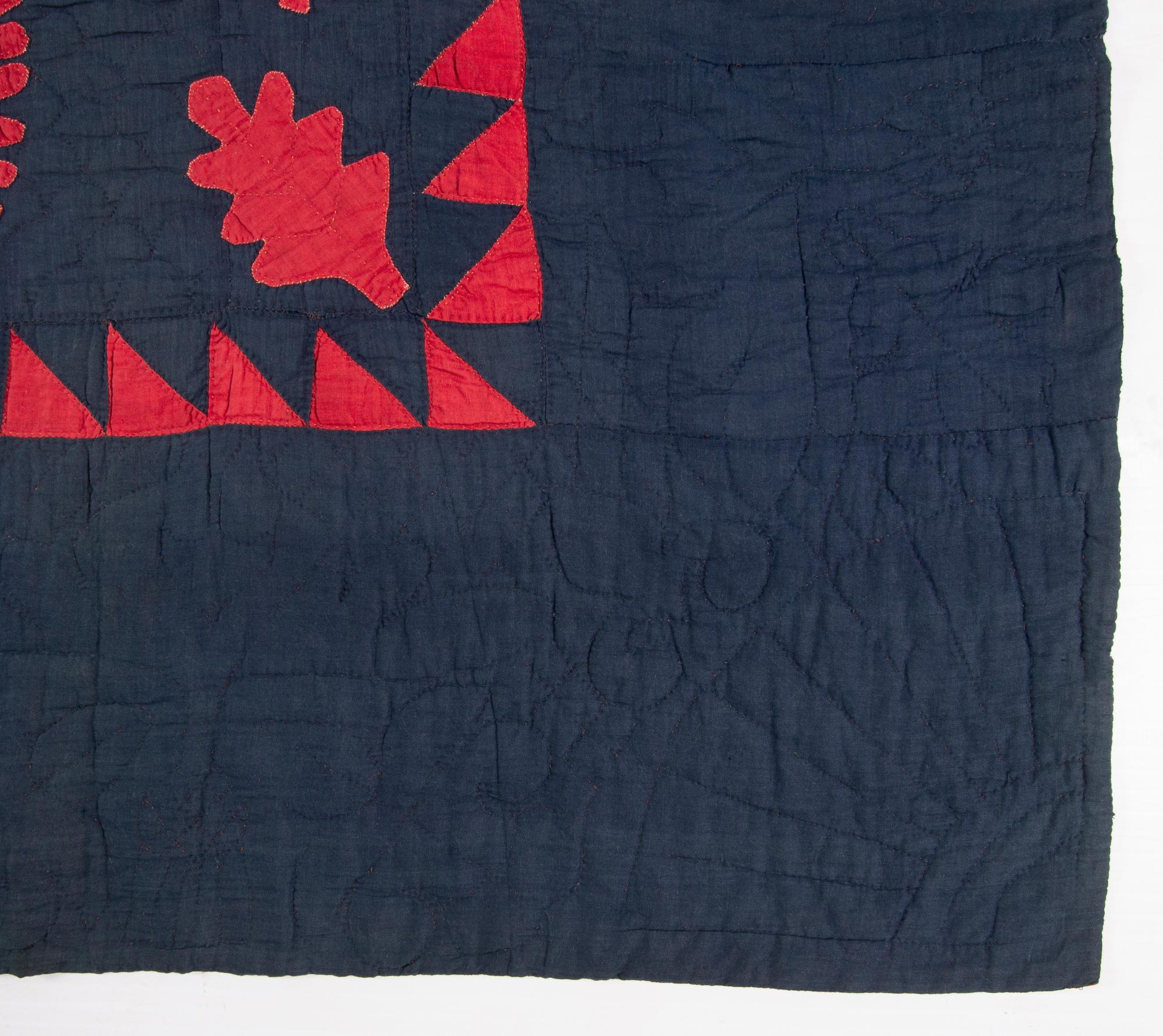 Red and blue princess feather pattern quilt with interspersed oak leaves and a sawtooth border. Made circa 1870-1885, this stunningly visual textile is highly unusual due to its dark blue ground and red elements. Most all early quilts in this style