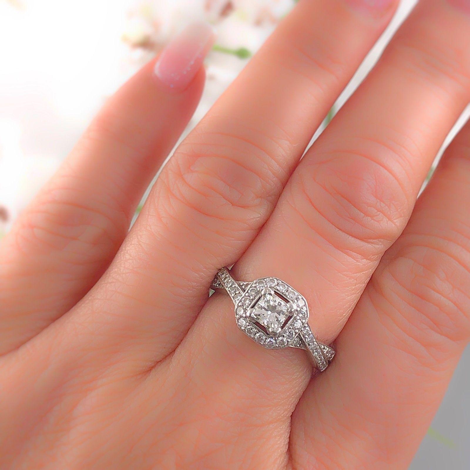 PRINCESS DIAMOND ENGAGEMENT RING
Style:  Halo with Twisted Diamond Band
Metal:  14k White Gold
Size:  6.5 - sizable
Total Carat Weight:  1.00 tcw
Center Diamond Shape:  Princess Cut ( Square Modified Brilliant ) 0.485 cts G color, SI1