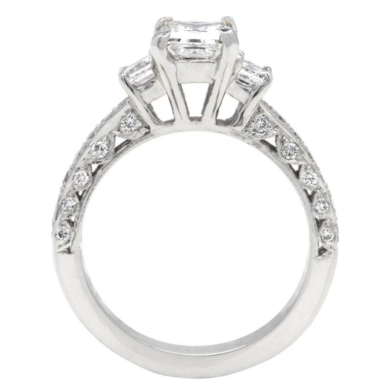 This gorgeous ring features a Princess cut Diamond, J Color VS2 Clarity GIA certified 1.00ct center stone set on a 14k white gold mounting with 1.40ct Princess cut side diamonds in G color VS1 clarity on the setting.