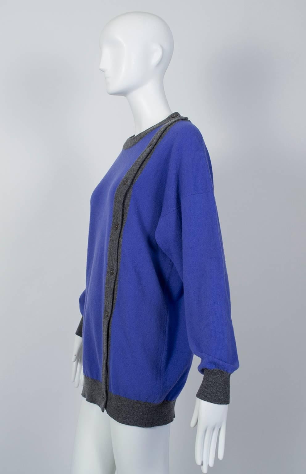 Beyond its forgiving, boxy cut and vibrant periwinkle color, the magic of this sweater is its fully unbuttoning asymmetrical front closure. Leave a few buttons undone at the hemline for a custom vent or unbutton the whole thing for an off-kilter