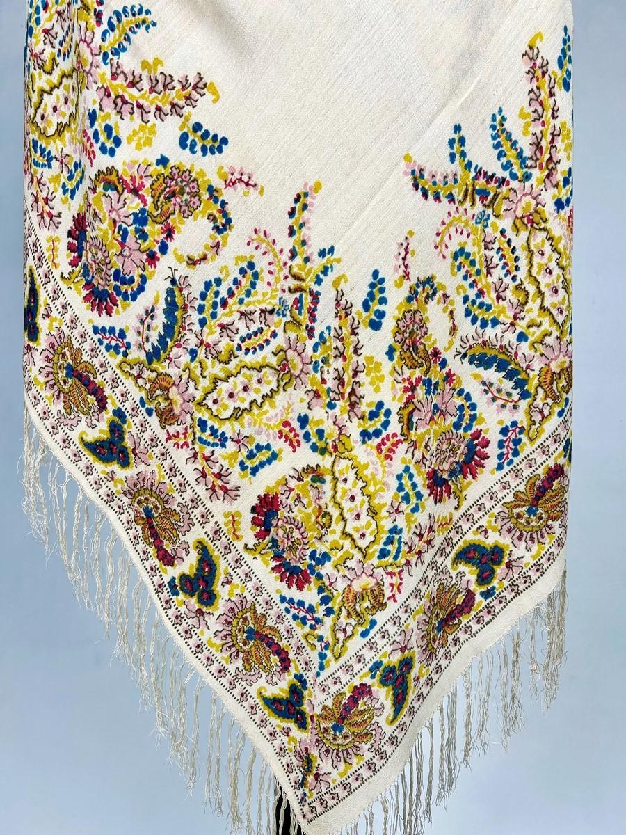 Circa 1880-1900
France or England

Beautiful square fichu shawl in paisley-printed crepe de Chine dating from the late 19th century. Design with four borders of large boteh slanted and treated with angular designs called ‘baton rompu’. Very fluid