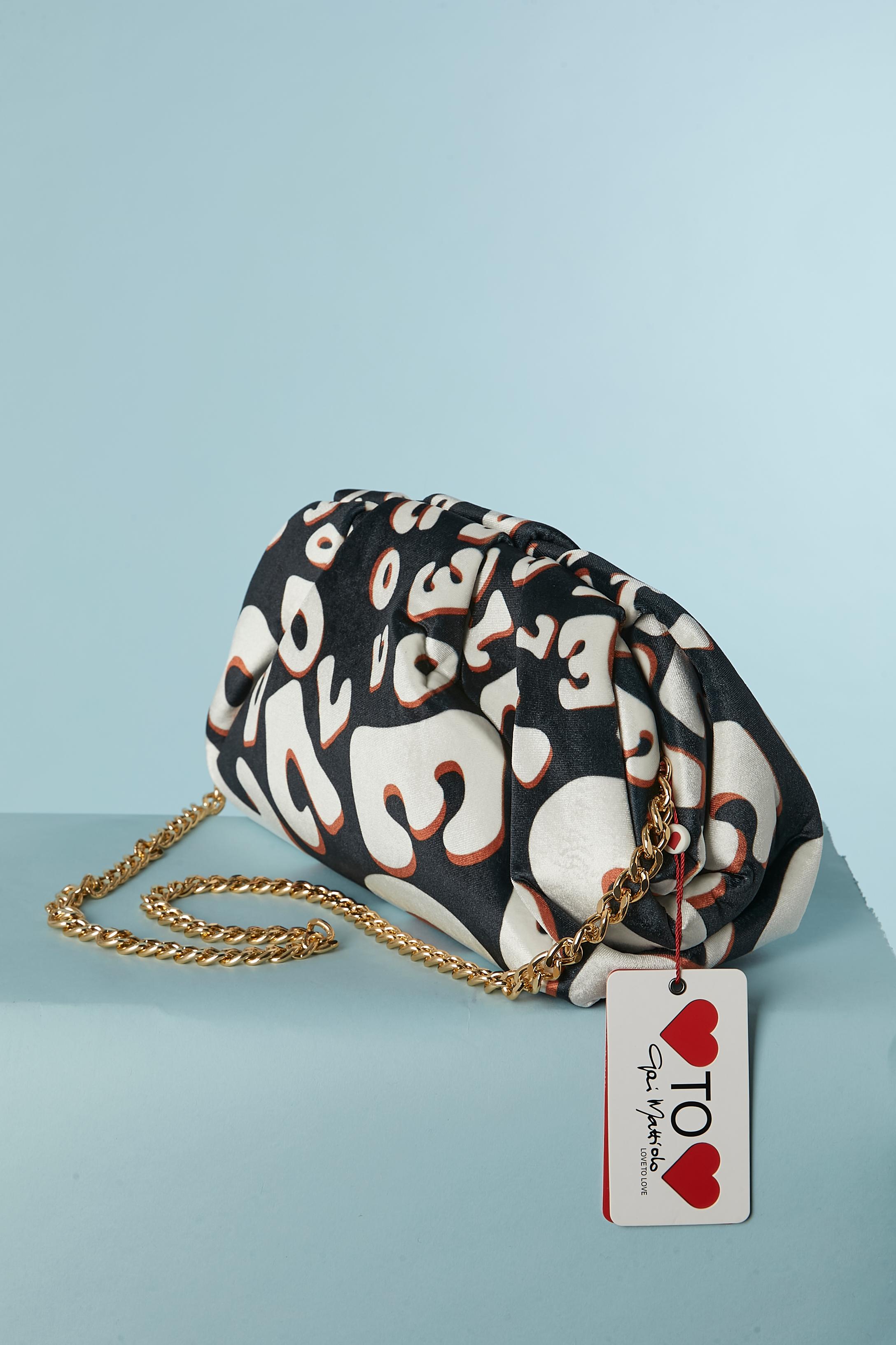 Printed fabric bag with gold metal chain. No fabric composition tag but probably polyester velvet. Magnetic closure on the top on the black leather. One pocket inside with zip closure. 
SIZE : 30cm X 20cm X 10cm 
Chain lenght: 95cm
NEW WITH TAG 