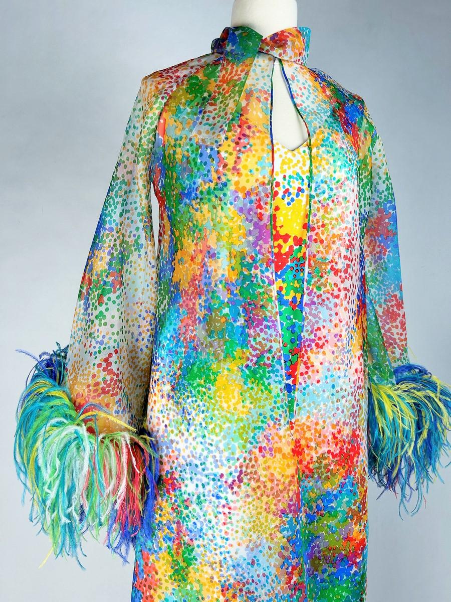 Circa 1975
France
Spectacular unidentified Haute Couture ensemble, dedicated to a ceremony and composed of a long dress and coat in silk and feathers inspired by Impressionist painting. Sleeveless strapless dress with V-neckline and back zip.