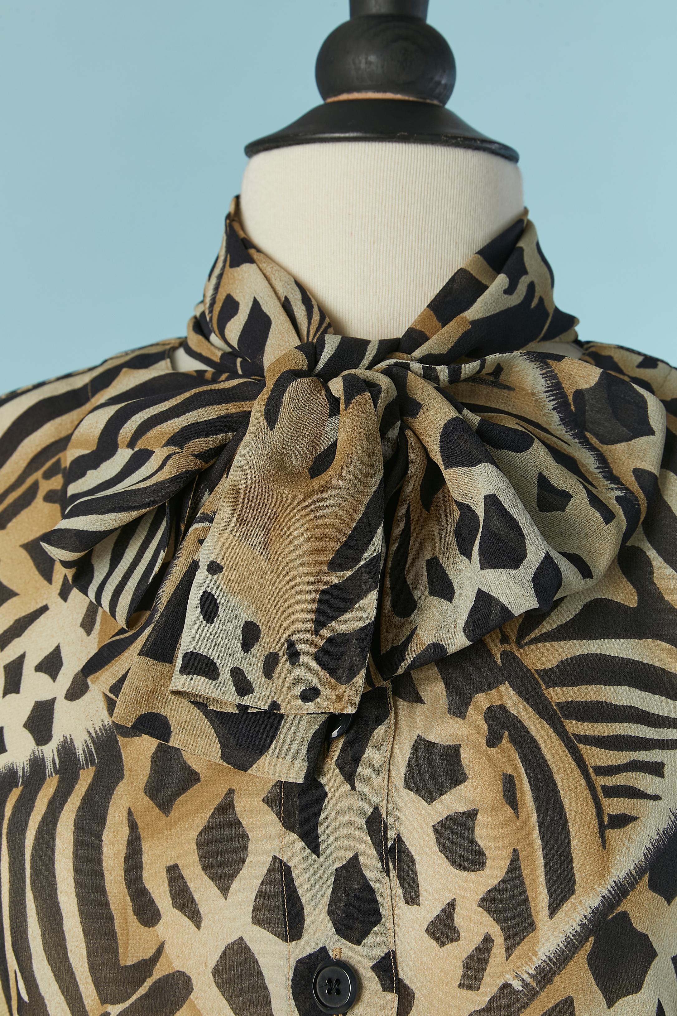 Printed silk chiffon shirt  with bow tie . Button and buttonhole closure on the middle front + on cuffs and one extra button provided 
SIZE 38 on tag but fit L 