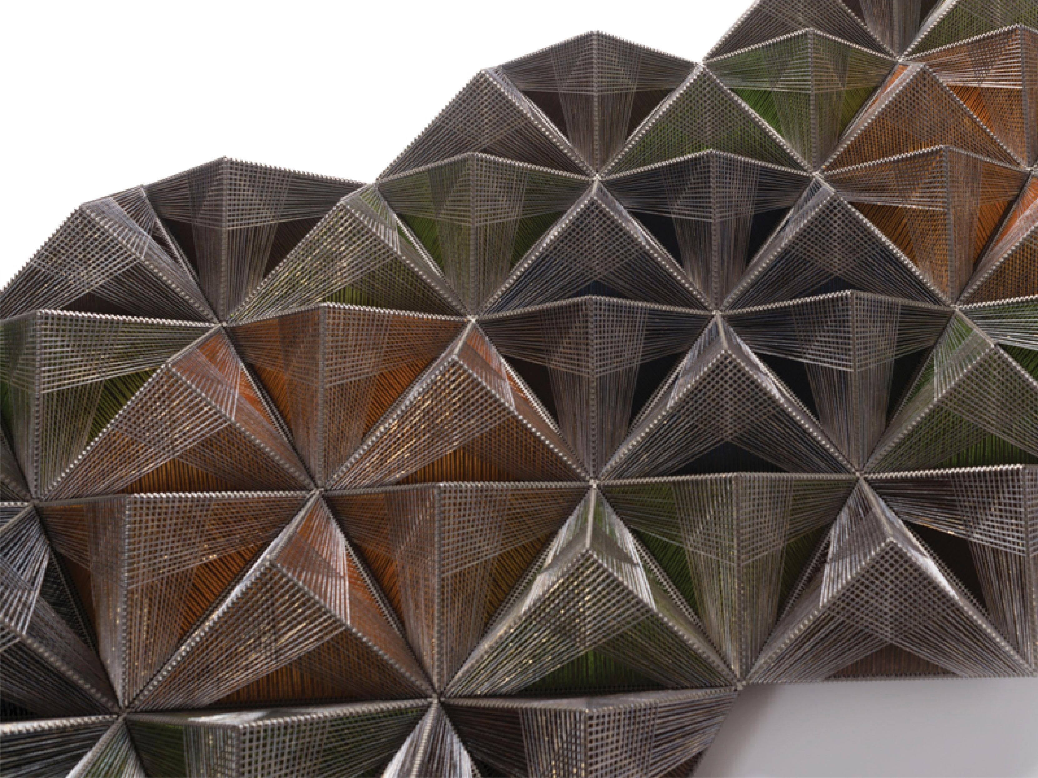 This wall decor piece is a sophisticated and modern prism-inspired design that seamlessly blends silk, cotton, and PVC materials to create a striking visual statement. The design features angular, geometric shapes that form a prism-like structure,